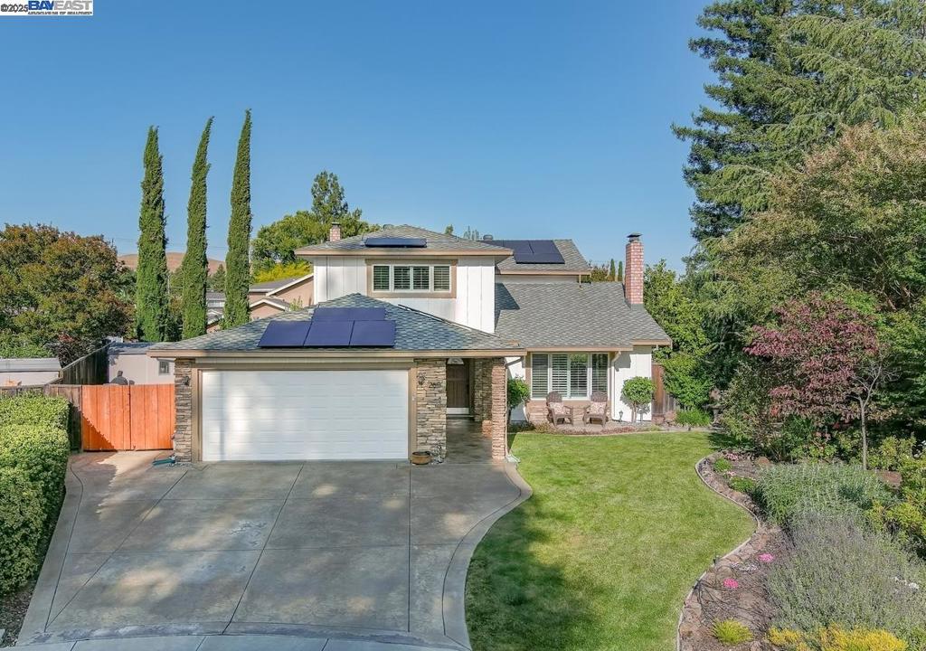 Tucked at the end of a quiet cul-de-sac in San Ramon, this beautifully updated home with Owned Solar sits on a nearly 10,000 sq ft lot and offers the perfect setting for peaceful living and memorable gatherings. A vaulted-ceiling Living Room features plantation shutters and luxury vinyl flooring that continues throughout the home. Just beyond, the Formal Dining Room captures a picture-perfect view of the beautifully landscaped backyard through large windows. The updated Kitchen includes white cabinetry, quartz countertops, counter-to-ceiling tile, and stainless steel appliances, including a 5-burner electric range with double ovens. The adjacent Family Room features custom built-ins and French doors with phantom screens opening to the backyard. Also on the main floor is a bedroom with built-in desk and cabinetry, ideal for guests, extended family, or remote work, plus a half bath. Upstairs, the spacious Primary Suite has his-and-her closets and an updated en-suite bath. Two more bedrooms share a hall bath. The backyard is the showstopper—a 12-foot deep pool with diving board and spa, a wide patio for entertaining, lush lawn, fruit trees, stamped patio, and two storage sheds. Walk to schools, trails, parks, and City Center. OPEN HOUSE Sat/Sun, August 16 and 17, 1-4pm