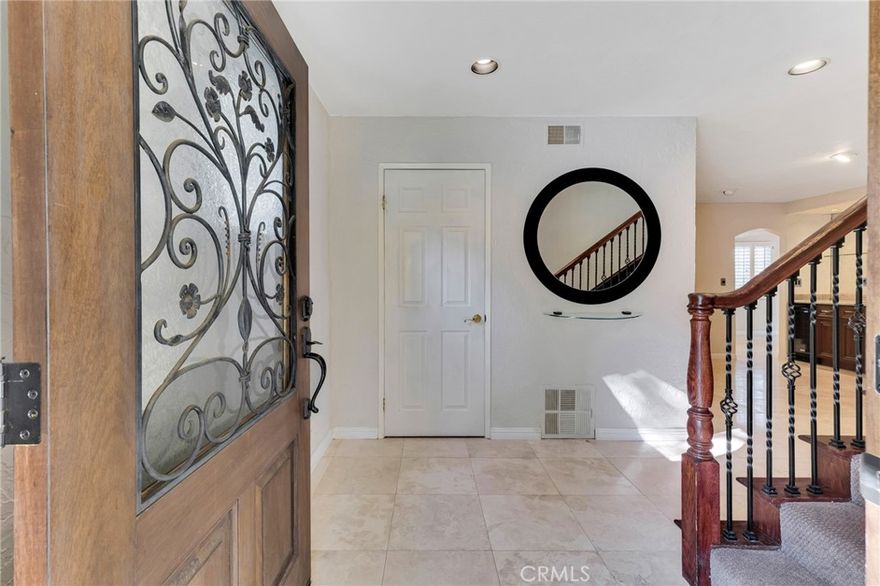 Welcome to 22781 Macfarlane Drive, a private retreat tucked away on a desirable flag lot offering space, comfort, and exceptional indoor-outdoor living. This expansive home features 3 bedrooms, 4 bathrooms, and a large, versatile downstairs bonus room—ideal for a home office, gym, media room, or guest suite. The spacious living room features a fireplace and is enhanced by French doors with sidelights that open to the backyard, filling the home with natural light. Designed for entertaining, the formal dining room includes a wet bar and wine refrigerator, seamlessly connecting social spaces. The chef’s kitchen is both stylish and functional, showcasing granite countertops, stainless steel appliances, rich dark wood cabinetry, a trash compactor, pot filler above the stove, and a generous walk-in pantry with brushed-glass double doors. A cozy eat-in kitchen area flows effortlessly to the backyard through sliding glass doors. Step outside to a true entertainer’s paradise featuring a built-in BBQ, refrigerator, outdoor TV, and a sparkling pool and spa—perfect for hosting gatherings or relaxing under the stars. The tranquil yard is complemented by mature fruit trees, including lemon and orange trees, dragon fruit vines, and views of the West Valley. Inside, travertine tile flooring enhances the main level, while the upper floor offers a spacious primary suite with his and her bathrooms, along with two secondary bedrooms that share a full bathroom. Additional highlights include plantation shutters, newer windows, ceiling fans, elegant arched entryways, an indoor laundry room, pull-down attic access in the garage, and fresh paint and new carpet. Ideally located just minutes from premier dining, shopping, and entertainment, with easy access to The Commons at Calabasas, Westfield Topanga, and The Village, this home offers privacy, convenience, and an exceptional lifestyle in one remarkable setting.