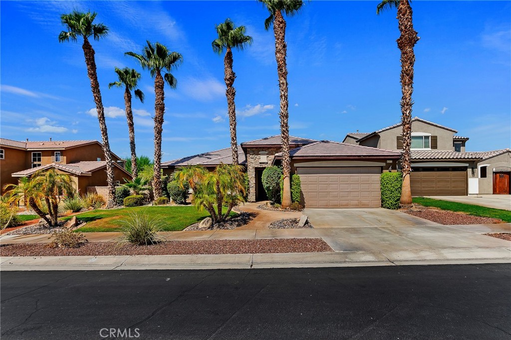 From the moment you drive up to this North Indio masterpiece, you will be transcended into a world of luxury living, coupled with the perfect home. This traditional style Terra Lago home has it all - 3 bedrooms, 2 full bathrooms, 2012 square feet of living space, attached two-car garage and the lush landscaping gives this house charming curb appeal. Single entry door leads to a light & bright airy floor plan w/low maintenance tile flooring, neutral color paint throughout, panel doors at all rooms, dual pane windows w/custom treatments, Bluetooth surround sound speakers inside & out and recessed lighting. The Laundry room has washer/dryer, upper cabinets and desired utility sink. An exquisite, open-concept gourmet kitchen features an abundance of raised panel cabinets, gleaming Granite counters/backsplash, pantry, full set of stainless-steel appliances, huge center island perfect for interacting w/guests, breakfast nook w/workstation, French doors giving access to the entertainment style backyard and is open to the combined family & dining rooms. The family room w/large windows for desired natural light, TV over the custom fireplace, niche w/built-in cabinet and the formal dining room is great for hosting on any occasion. Two guest bedrooms to the front of the house are good in size w/ceiling fans and share a full guest bathroom w/dual his/her vanity and shower/tub combo. The well-designed primary bedroom is a personal retreat w/views/natural lighting, ceiling fan, en-suite bathroom with tile floors, dual vanity, soaking tub to relax, walk-in shower, privacy toilet room and walk-in closet. A two-car garage provides convenient storage and parking. The backyard is an entertainer’s paradise featuring French pattern pavers, covered patio w/ceiling fan, LED lit spa w/ledgestone waterfall, built-in BBQ station w/seating, commercial grade mister nozzles, LED landscape lighting, and the fire glass fire bowl to enjoy serene mountain views & endless sunsets. This home is conveniently located to the community clubhouse, pools, a quick stroll to the 20-acre lake, The Golf Club at Terra Lago, music festivals, minutes to Fantasy Springs Resort & Casino and Acrisure arena.