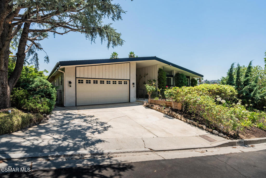 Within this wonderful Tarzana neighborhood surrounded by rolling hills, a desirable single story home is offered having amazing views. It has kept its charm of its mid-century build, note the accents of its archetypal entry, be greeted by a spacious sky-lite porch covered by its wide-sloping open gable roof. Step into the living room which has windows overlooking the pool and view and a central brick fireplace. Proceed to the family room which has another fireplace, a bar area, recess lighting, and a sliding window door to the backyard. Adjacent is the formal dining room and its kitchen which features: a cozy nook; another sliding window door to the backyard; ample cabinetry; attractive tile countertops; and recess lighting. The primary bedroom features a large window to the backyard and has a primary bathroom with a tile floor, shower/tub, and walk-in closet. There are: 3 additional bedrooms; a second full bathroom with double sinks; a granite countertop; and there is direct access to the side of the home leading to either the back or front yards. A third full bathroom has a direct entry from one of the bedrooms. Enjoy entertaining and lounging in your backyard which includes: a covered patio; sparkling pool; a circular firepit with brick accents; privacy is enhanced by how the home is situated with its landscaping; and note the breath-taking backyard view. Additional features include: a central laundry room; recess lighting; and plantation shutters. This home offers endless possibilities to buyers who wish to customize and is situated close to schools, parks, shopping and recreation. The gorgeous views are a must see!