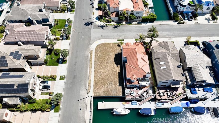 An incredible opportunity awaits in the highly desirable Mandalay Bay! This rare private corner lot offers approximately 46 feet of waterfront with expansive deck possibilities, making it the perfect setting to design and build your dream home. Positioned on a wide channel with easy access to the water, you’ll enjoy the ultimate coastal lifestyle. With its west-facing orientation, this property captures breathtaking sunsets and serene water views, providing a one-of-a-kind backdrop for everyday living. There are plans available to build a 4,000 sqft home with a 3 car garage that includes 5 bedrooms and 5.5 bathrooms! Don’t miss the chance to create your own waterfront retreat in one of the area’s most coveted communities.