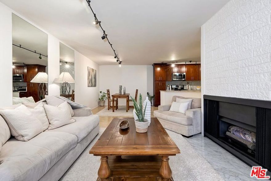 Welcome to your serene urban oasis. This spacious, thoughtfully updated one-bedroom condo is one of the largest floor plans in the building and shares only one common wall for added privacy. The open-concept layout flows seamlessly from the renovated kitchen to the dining and living areas perfect for both daily living and entertaining. The kitchen features elegant granite counters, abundant self-closing cabinetry, tile backsplash, and stainless-steel appliances including a gas range, new dishwasher, and refrigerator. Enjoy a cozy fireplace and step out to your semi-private balcony nestled within a recessed outdoor alcove, an ideal space to relax or entertain. Plantation shutters throughout offer a clean, classic touch while providing light control and privacy. The updated bathroom offers tasteful finishes and extra storage, and the sunlit bedroom features dual closets for smart organization. Resort-style amenities include a rooftop pool and spa with panoramic views of the Hollywood Hills, Griffith Observatory, and the Downtown Los Angeles skyline, plus a sundeck with BBQs and clubhouse. Plus, gym, sauna, nighttime/weekend security guard, controlled access and an onsite maintenance staff and manager offer added peace of mind. Located on a tree-lined street with a strong sense of tranquility & community, you're just moments from local cafes, dining, and everything LA has to offer. This beautifully maintained condo offers the ideal blend of comfort, convenience, and city living. A must see!