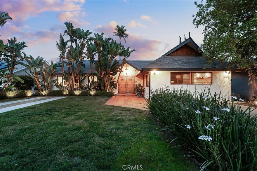 Sensational single story Spanish pool home with detached guest unit! Set back from the street with sprawling front yard with lush landscaping, grass lawn, long driveway, and second driveway ideal for RV/boat parking. A Saltillo tile pathway leads to the gorgeous double door entry. Step inside to find a completely open floor plan with designer finishes and custom details. An expansive entry foyer opens to the formal living and dining rooms featuring accent walls, oversized windows, real hardwood floors, and glass slider that opens to the backyard. The chef’s kitchen opens directly to the living spaces and boasts island with breakfast bar seating, quartz counters, soft close cabinetry, and stainless appliances. A separate large family room offers great versatility for additional flex space. There are four bedrooms in the main house including the luxurious primary suite featuring custom built-in closets and en-suite private remodeled bathroom with walk-in shower. The three secondary bedrooms each have closets with custom built-ins. A spacious remodeled hall bathroom has dual sinks and and walk-in shower. There is another full bathroom also ideal for guest use with designer tiling and walk-in shower. A separate laundry/mud room area has custom storage cabinetry. The detached guest unit is approx. 450 SF and features bedroom studio with closet, living space, kitchenette with fridge and sink, and en-suite bathroom with walk-in shower. The super private entertainer’s backyard is a true tropical oasis boasting sparking swimming pool, built-in gas fire pit, BBQ center with refrigerators and cement wraparound counter with bar seating, spacious patio adorned with Saltillo tiling, large storage room, and lush landscaping with twinkle lights that create the ultimate vacation ambiance. The property also features per seller: Control 4 smart home automation for music and lighting, Ring alarm system, security cameras, as well as brand new roof. Ideally located adjacent to dining/shopping at the Westfield Mall & Village, Warner Center, and Topanga Canyon.