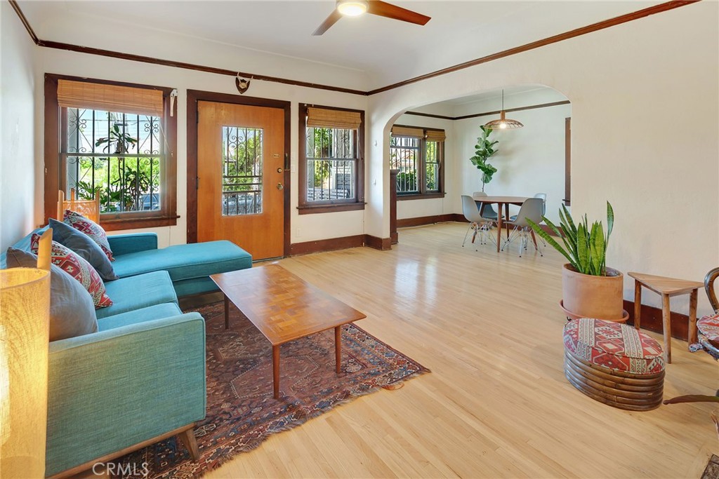 A true gem in the heart of Boyle Heights! This beautifully preserved 1920s Craftsman home is filled with original charm and thoughtful modern upgrades. Meticulously maintained and lovingly restored, it offers the best of both worlds: vintage character and updated systems that make homeownership simpler. Step inside to discover classic details like the Batchelder tile fireplace, original built-ins, and coved ceilings. Refinished original hardwood floors flow seamlessly into new bamboo flooring. The remodeled kitchen is a showstopper, featuring stainless steel appliances, quartz countertops, a farmhouse sink, and plenty of cabinet space. Three spacious bedrooms provide room to stretch out and settle in. The main bathroom pairs an original tile vanity with an updated, easy-to-maintain tub shower. An additional half bath off the laundry area adds convenience for hosting. Updates behind the scenes include a new roof (2018), upgraded electrical panel and full rewire (2018), foundation retrofit (2019), and a whole-house water filtration system. Need bonus space? The converted garage with its own bathroom is ideal for a home office or creative studio—overlooking the peaceful back patio and garden with mature fruit trees and 40-year-old rose bushes. Zoned LAR2, this property offers future flexibility. You may also qualify for a $20,000 homebuyer grant! This home is full of soul and ready for its next chapter. Come feel the warmth and make it yours.