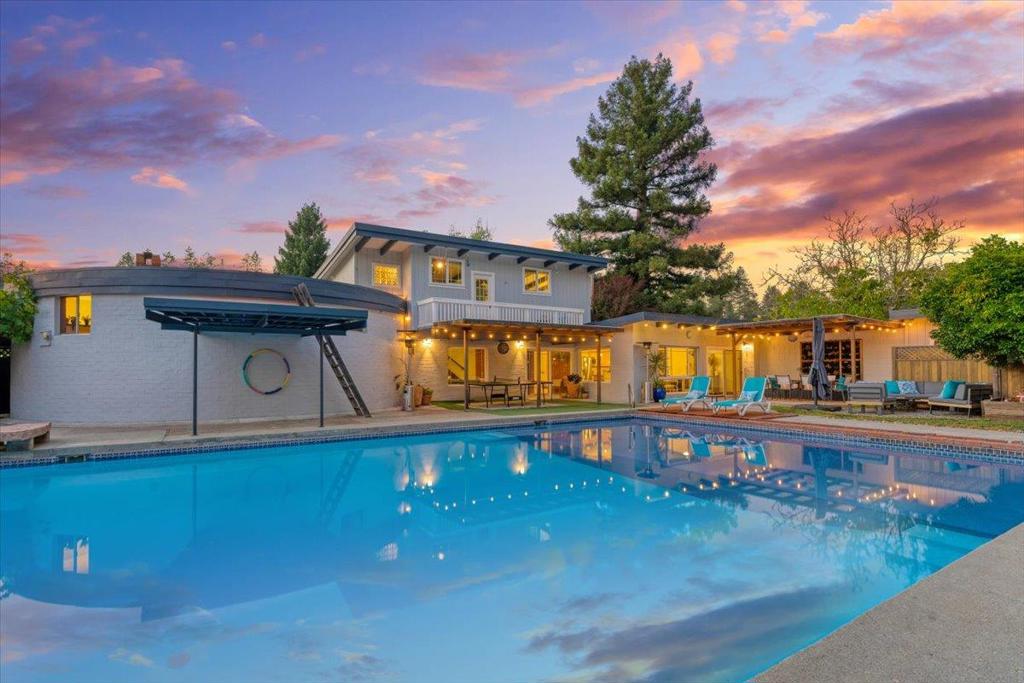 Mid Century Charm Meets Private Retreat. Discover a one of a kind sanctuary at 368 Green Valley Road, blending mid century modern design with natural serenity. The 3 bed, 3 bath main home offers 2,336 sq ft of light-filled space, featuring iconic architectural details, soaring windows, and artistic touches throughout. A private, enclosed courtyard connects the detached 2 car garage to the main entrance, setting a tranquil tone. Inside, nearly every room offers lush garden and pool views, blending the line between indoor comfort and outdoor beauty. A separate 416 sq ft guest house with 2 beds and 1 bath adds flexibility, ideal for extended family, guests, a home office, or studio. Set on a 13,896 sq ft lot, the backyard is a private oasis with a sparkling pool, mature landscaping, and multiple patios perfect for entertaining or unwinding. Additional highlights include off street parking, secluded surroundings, and a prime location minutes from top-rated schools, town amenities, and commuter routes. More than just a home, this is an unforgettable retreat in one of Scotts Valleys most sought-after neighborhoods.