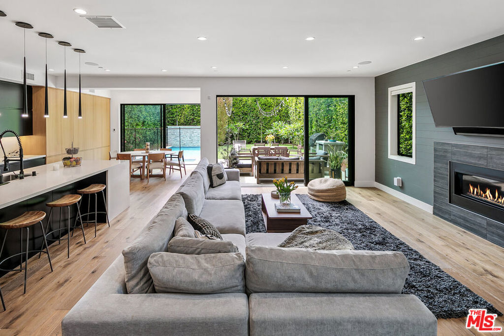 Drive through the automatic gate to this private architectural home and be transported into your tranquil coastal retreat. Built in 2019, fully furnished, and for the first time ever this beautiful home is being offered as a lease. This modern and bright 5 bedroom, 4 bath home features a formal dining area, a guest bedroom/office, a full bath, a spectacular gourmet kitchen with a walk-in pantry, an oversized island, and a breakfast bar. The great room has a fireplace and floor-to-ceiling glass stacking doors that open to a sun-drenched entertainer's backyard. The yard features a luxurious heated pool, spa, lush walls of tropical greenery, a mature fruit garden, and a spacious lawn. The built-in BBQ, outdoor Sonos speakers, and string lights maximize the home's indoor-outdoor living experience. Upstairs, you'll discover the primary bedroom with a cozy fireplace, a large, light-filled bathroom with a freestanding soak tub, a walk-in shower, dual sink vanity, and a walk-in closet. On the second floor, you will also find 3 spacious bedrooms, 2 full baths, and a 2nd-floor laundry room. 1037 Palms is located in a prime Venice location, steps away from the hottest destinations on Lincoln Boulevard, including Superba, Zinque, and Barry's Bootcamp. You will be a short stroll from iconic Abbott Kinney shopping and restaurants, a 1.5-mile bike ride to Venice Beach, and have easy access to LAX, the 10, 405, and 90 freeways. Grab your bike, surfboard, toothbrush, and come experience life in Venice! 13-month minimum lease agreement.