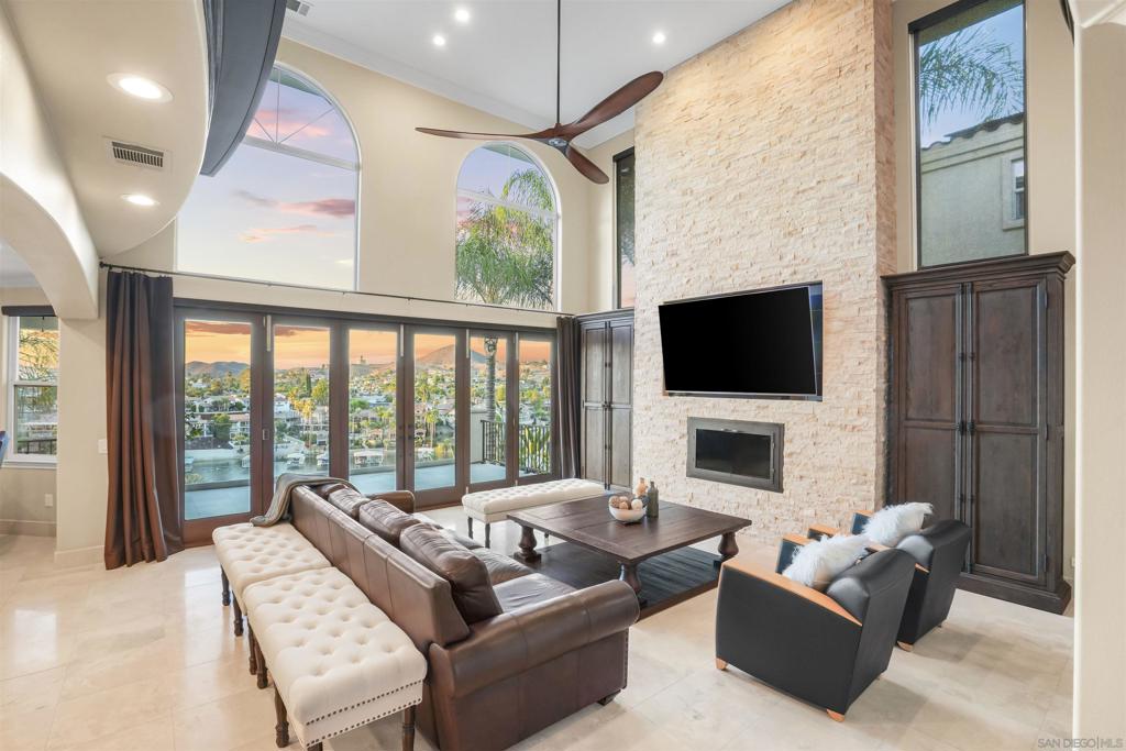 PAID SOLAR & BRAND NEW DOCK WITH LIFT...This stunning East Bay waterfront home truly has it all—impeccably maintained and thoughtfully designed to capture panoramic lake views. Step through the grand entrance and be immediately impressed by a sweeping curved wrought iron staircase and breathtaking views of the lake the moment you walk in. Enjoy seamless indoor/outdoor living with La Cantina doors that open to a spacious patio, sparkling pool (with new paid solar), and the lake just beyond—perfect for entertaining or relaxing in style. Each level features its own private deck with ceiling fans for year-round comfort. The open-concept layout includes a main-level primary suite, an executive office, and a state-of-the-art home theater that rivals any cinema. Currently configured as 3 bedrooms plus an office and theater, the home can easily convert back to a 5-bedroom layout. Step outside to your own private dock—brand new and valued at $80,000—complete with a roof and hydro lift for effortless boating. Located in the exclusive Canyon Lake community, residents enjoy private lake access for boating, fishing, wakeboarding, and waterskiing. Additional amenities include parks, beaches, a scenic 18-hole golf course, lakefront clubhouse dining, junior Olympic-sized pool, tennis and pickleball courts, lakeside camping, and year-round community events. Golf cart-friendly streets make accessing it all a breeze. Live the ultimate lakefront lifestyle—this exceptional home delivers luxury, comfort, and unforgettable views on every level.