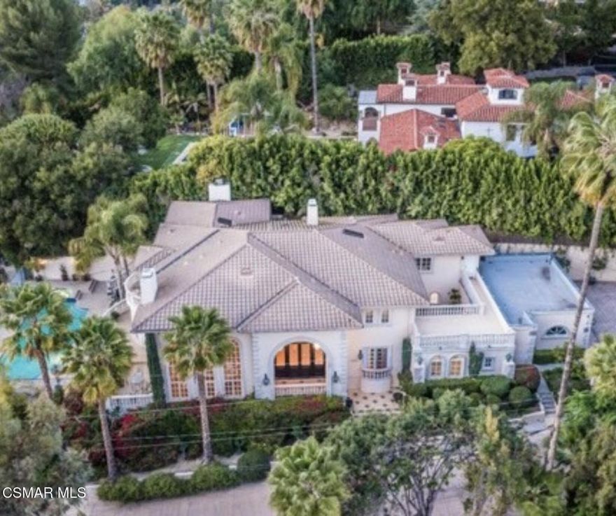 Experience one of the premier Italian Mediterranean estates South of the Blvd, ideally situated behind gates on a private road in the highly coveted Lanai School District. This exceptional location offers the best of Encino living--close to premier dining, shopping, the Westside, and major freeways--while still providing privacy, security, and a true neighborhood feel.A grand two-story foyer welcomes you into an open floor plan with soaring cathedral ceilings and generous living and entertaining spaces. French doors throughout the home create seamless indoor-outdoor flow to multiple balconies, terraces, and beautifully landscaped grounds. The formal living and dining rooms, walk-in wet bar, and expansive family areas make this home ideal for large gatherings and elegant entertaining.The gourmet kitchen features a Sub-Zero refrigerator, center island, butler's pantry, and two dishwashers, offering both functionality and convenience for hosting. Upstairs are 6 en-suite bedrooms, including a spacious primary suite with sitting area and fireplace, two walk-in closets, and a luxurious bath with dual vanities. Additional highlights include a private study with built-ins, a gym with steam shower, guest suite, maid's quarters, and custom wood floors.The resort-style grounds include a pool, spa, large lawns, gardens, fruit trees, and an interior courtyard with a tranquil water feature--perfect for relaxing or outdoor dining. A 3-car garage and ample parking complete the property.An extraordinary estate on an expansive lot in one of Encino's best locations--ideal for both families and entertainers seeking space, convenience, and top-tier schools.