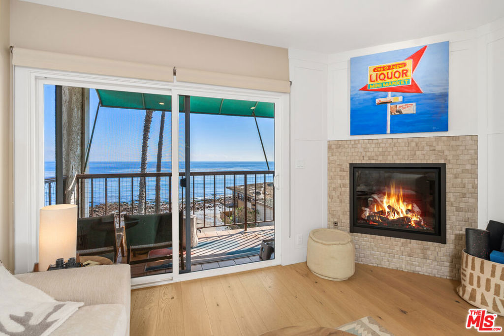 Breathtaking ocean views from your tranquil beach oasis. Step into your slice of heaven in this totally remodeled one bedroom, one bath condominium with an additional remodeled bonus room. A cozy fireplace adorns the spacious living room boasting heated engineered hardwood flooring and amazing views of the whitewater. Open, bright kitchen with skylight, Smeg Italian range and refrigerator, water purification system with instant hot water and built in Scotsman ice maker. Awaken in your sundrenched primary bedroom with stunning sunrise views and fall asleep to the gentle sound of waves rolling in. Roomy bathroom with an oversized shower, Icera bidet toilet, and high end fixtures. Designer ceiling fans add to the ocean breezes in your private oasis by the sea. Totally remodeled bonus room steps away with built in desk and storage closets. Resort style living at its finest with two tennis courts, heated pool, spa, gym, sauna and private beach with BBQ's and picnic tables. Excellent surf spot too! Rare opportunity to purchase an oceanfront condo at Tivoli Cove. Live the Dream in Malibu now.