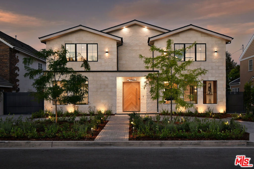Welcome to 112 South Valley, a newly constructed, modern masterpiece that redefines luxury living. Perfectly positioned on one of Burbank's most coveted cul-de-sacs, this home offers the best of both worlds: the peace of mind that comes with Burbank's exceptional city services, outstanding public safety, and top-rated schools, paired with the prestige, warmth, and community charm of Toluca Lake. The designer thoughtfully curated every detail of this 6,043 square-foot residence to showcase architectural brilliance and deliver the soul-stirring promise of a life well-lived. From the moment you arrive, the dramatic, solid white oak pivot front door opens to a world of refined elegance. Soaring ceilings and walls of Marvin windows flood the space with natural light, while rich textures, such as Marmorino Italian plaster and Portolan limewash, create an ambiance of sophistication. Whether you're gathering in the expansive living room, relaxing in the family room, or entertaining in the chef's kitchen adorned with custom Shinnoki walnut cabinetry, oversized double faucet sink, Thermador appliances, and a sleek butler's pantry, this home is an experience of flow, function, and flawless beauty. Five en-suite bedrooms, each a private retreat, offer comfort and serenity. The primary suite, situated above the expansive landscaped grounds, features a spa-inspired bath, a custom walnut walk-in closet, and a balcony where you can greet the day with sunshine and the soothing sounds of the morning air. Downstairs, a state-of-the-art theater, rec room, bonus space, and a sleek bar come together to create the ultimate setting for fun and entertainment, whether you're hosting game night, enjoying a movie with family, or simply unwinding with friends in style. Step outside and be transported. The backyard is a sanctuary of its own, featuring a black-bottom saltwater Pebble Tek pool with a Baja shelf and spa, two innovative motorized patio systems, an Ipe wood fire pit bench, and a complete outdoor bath/mudroom. Entertain effortlessly or unwind in total privacy beneath the stars. The home offers the latest in technology and convenience, featuring Control4 smart home automation, a quad-zone Carrier climate control system, an integrated sound system, custom lighting, and sleek Samsung washer/dryers. Additional amenities include fully underground electrical, solar panels for enhanced energy efficiency, and an electric car charger in the spacious garage. Every element from fluted limestone accents to custom linear drain installations reflects the highest standards of design and craftsmanship. However, the true luxury of 112 South Valley lies in the lifestyle it offers. Here, neighbors greet each other by name. Stroll into Toluca Village for your morning coffee, dine al fresco at your favorite local spot, or attend a community event where everyone feels like family. You're minutes from top-rated schools, major studios, the Lakeside Golf Club, and iconic LA landmarks like Griffith Park and the Hollywood Bowl. 112 South Valley is more than a home, it's your place in a vibrant, welcoming community with a rare opportunity to live in modern splendor, in a neighborhood where connection and character matter.