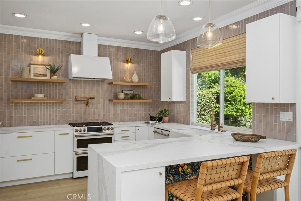 This gorgeously remodeled 4-bedroom + loft, 3.5-bath home sits behind the gates of Canyon View in one of Irvine’s most desirable neighborhoods. Professionally designed with wood-look floors, custom wall paneling, and designer wallpaper, every detail has been thoughtfully curated.
At the heart of the home is the chef’s kitchen with an oversized island, designer tile backsplash, pot filler, and abundant storage. It opens seamlessly to the spacious family room with fireplace and flows into the formal living room, dining room, and eat-in kitchen area—multiple living spaces perfect for today’s lifestyle. A stylish powder room completes the main level.
Upstairs, discover a versatile loft, a private secondary suite, and the stunning primary retreat. The spa-inspired primary bath features dual vanities, a soaking tub, and a walk-in closet—your own private sanctuary.
Outside, the expansive yard with turf landscaping provides the perfect setting for entertaining or relaxing year-round.
Residents enjoy resort-style amenities including pools, spa, tennis courts, and sports parks, along with award-winning Irvine schools just a short distance away. Shops, dining, and trails are all nearby.