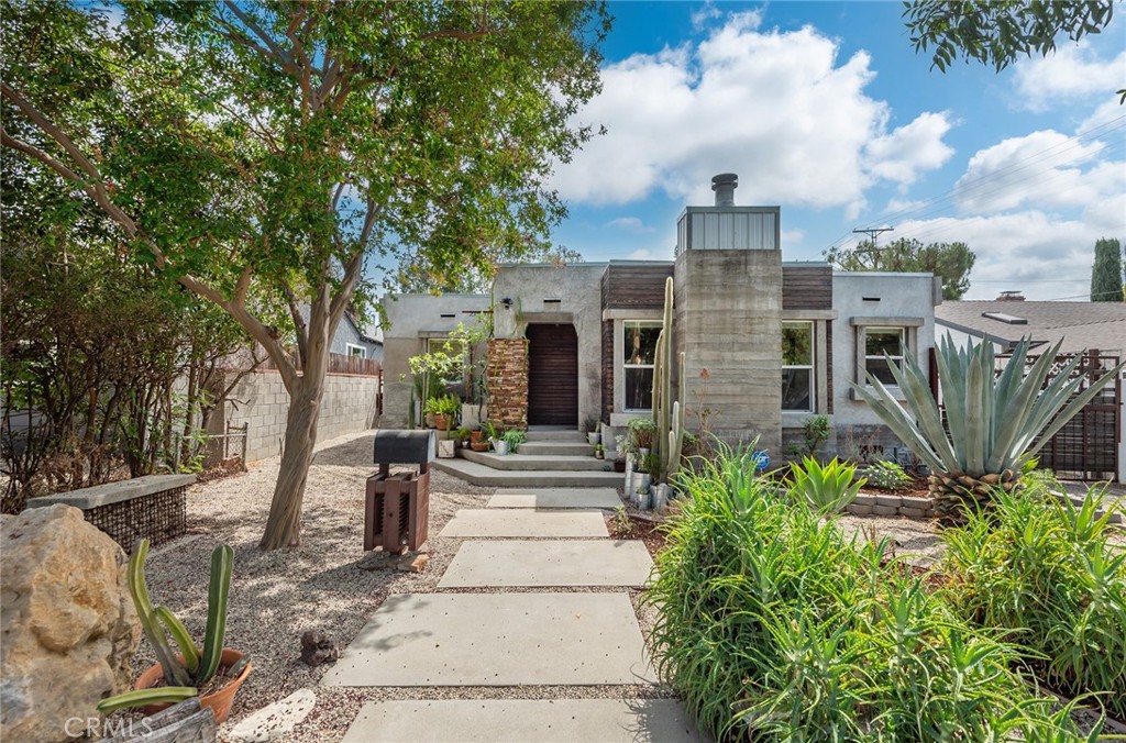 Unique South of the Blvd. Custom Contemporary Industrial design. This concrete home was remodeled from the studs and is Insulated throughout. Gleaming concrete floors, skylights ,dual pane windows, Industrial custom gas/ wood fireplace in the living room. Open floorplan with plenty of windows for a light and bright feeling. Kitchen features sink island cement counters with stainless steel GE profile gas range and dishwasher. The main bedroom features new flooring and large walk in closet as well as access to the backyard. Nice size secondary bedroom with a spacious closet, high ceiling and exposed ducs vents. The Bathroom has spa like feeling with a walk in glass shower and natural light. Newer electrical and copper plumbing, tankless water heater. 3 ton HVAC. Enjoy a private backyard with fresh natural grass and and multiple sitting areas. The 2 car detached garage in back is ideal for a potential studio, guest suite or a great workspace. There is plenty of side parking on the driveway, the home is gated. Enjoy the Beautiful drought resistant front and back landscaping while saving on your water bill. Ideal Location: Woodland Hills Elementary, Shops at Topanga Canyon, short distance to Ventura Blvd, only 15 min. to the Beach and 5 Min to major Freeways.