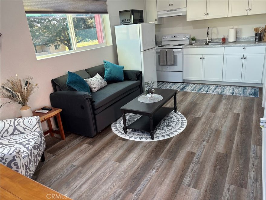 1472 sq.ft. manufactured home with two bedrooms & two bathrooms on OWNED LAND with a DETACHED PERMITTED ADU. The ADU is an additional one bedroom & one bathroom, approximately 375 sq.ft.  It is a garage conversion that was completed in Dec. 2025 with a permit by a licensed contractor.  New and fresh, never lived in.  Mini split system for AC/heat, it's own hot water heater & stackable washer/dryer in the ADU.  NO space rent or HOA fees.  The manufactured home is on a permanent foundation with 433A on file so financing is available.  Located on a corner lot in Folkert Oaks subdivision in Nipomo. Parking for six vehicles in driveway or back your RV/travel trailer in & connect to the RV hookups & cleanout.  2022 upgrades include: exterior paint, artificial grass, driplines, decomposed granite added in yard, ceiling fans & new luxury vinyl tile flooring on the inside.  Interior and kitchen cabinets painted in 2020.  Wood pellet fireplace in living room.  New redwood fencing in 2025.   Five wall mounted TV's and all of the half wine barrels with planted trees are included in sale.