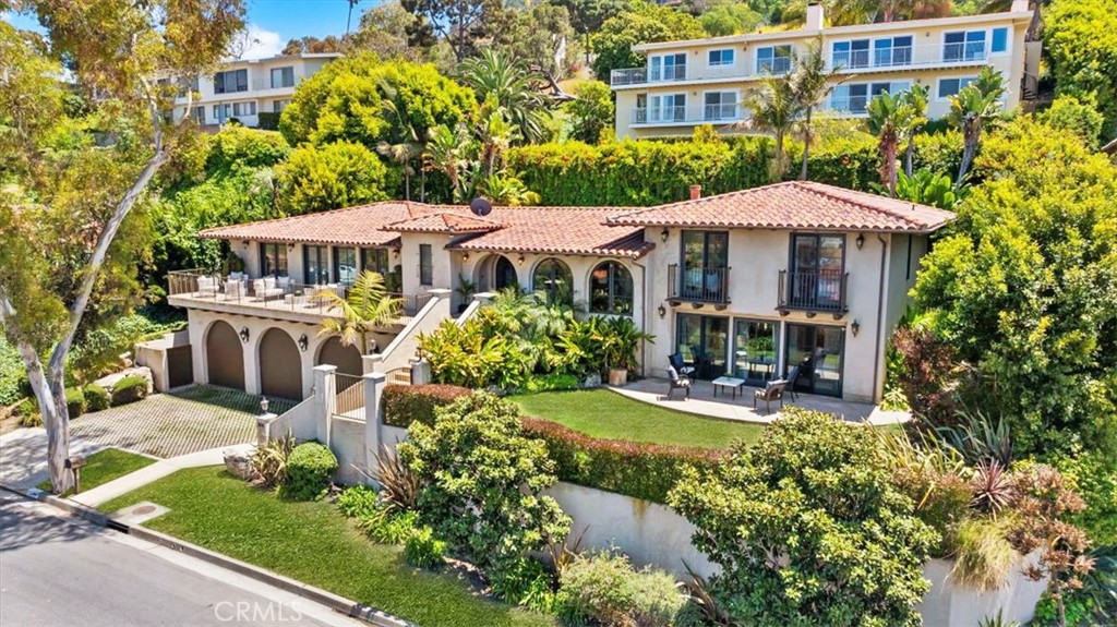 Nestled in the heart of Lower Malaga Cove, 364 Via Almar is a beautifully refreshed Spanish-style residence that captures the essence of coastal California living. Extensively remodeled in 2008, this elegant 5-bedroom, 4-bathroom home spans approximately 3,515 square feet and is situated on a generous 10,492-square-foot lot with breathtaking views of the Pacific Ocean and Queen’s Necklace. Inside, you’re welcomed by an open floor plan with natural light throughout. The gourmet kitchen is a chef’s dream, featuring a large center island, top-of-the-line appliances, and a bar area with wine cooler—perfect for entertaining. French doors throughout the home open to balconies and patios, seamlessly blending indoor and outdoor living. The luxurious primary suite offers an oversized walk-in closet and spa-like bathroom with dual vanities and a soaking tub. Additional highlights include a private elevator, an oversized three-car garage, large storage area, ceiling speakers and gated grass area. The flat backyard features a pool and spacious patio, ideal for relaxing or hosting gatherings. Located within the award-winning Palos Verdes Peninsula Unified School District and just moments from the Palos Verdes Beach & Athletic Club, Malaga Cove Plaza, amazing surf and walking trails, this exceptional property offers both luxury and lifestyle in one of the South Bay’s most prestigious neighborhoods.