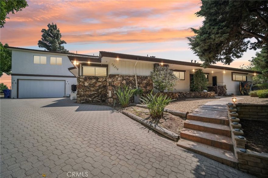 An exquisite, ultra-private entertainers home awaits you in the prestigious community of Knollwood Estates. This stunning immaculate 6 bedroom/7 bath home is full of character and charm. A modern feel with a twist of Mid Century. Super private 17, 358 sq/ft lot, that is set back off the street, allowing for tree top and city views. The moment you walk in you are greeted by the mesmerizing wood beamed vaulted ceilings and the view of the relaxing pool and treetops beyond the oversized glass sliders. Large eat in kitchen with center island, tons of cabinets/storage and stainless steel appliances. Butlers’ kitchen/pantry area is strategically situated with commercial-style fridge, sink, double oven and more storage. 2 primary suites one at each wing of the home. 1st Primary suite is located upstairs with skylights, oversized seating area, wrap-around walk-in closet , heated bathroom floors and balcony with amazing city & pool views. 2nd primary suite located on the main level also has relaxing views of the pool & tree tops, ample windows/glass sliders, oversized walk-in closet, his and hers bathrooms and even a relaxing/meditation outdoor area created off master bath. Enhance your health with your very own private infrared sauna! All bedrooms are good sized with plenty of storage space. Entertainers yard with heated pool, covered patio area, outdoor bathroom w/shower and several different areas to entertain throughout the large lot. NO detail has been spared. Some other features include oversized double fireplace, 3 HVAC zones, paid off/owned solar, exterior roll down blinds and so much more.