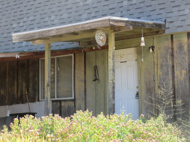 This 5 acre parcel on a PAVED road features a WELL, POWER, septic, and an adorable 1970's one bedroom mobile home in good condition. Live in the mobile home while building your dream home! This partially fenced lot also offers a great view of the valley. The rustic two-story barn has a kitchen, bathroom, & living area downstairs, and needs TLC. The property is very gently sloping and almost all usable. Native vegetation includes manzanita, pinon pine, and redshank. Value is in the land and utilities. Seller may finance!
