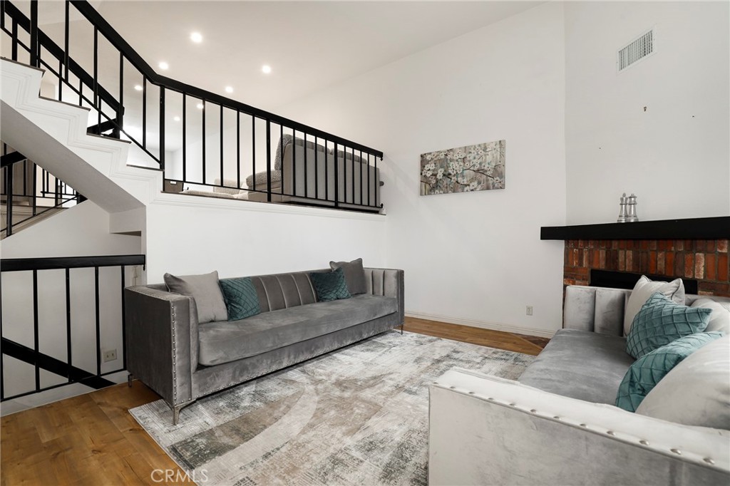 Nestled in the picturesque foothills of Duarte, this townhome-style residence offers the perfect blend of timeless comfort and modern upgrades. Inside, you’ll find a bright and open layout enhanced by soaring ceilings and abundant natural light. The main level features a welcoming living room with a cozy fireplace and direct access to a private balcony—ideal for BBQs or relaxing outdoors. The second floor seamlessly combines a spacious family room, dining area, and a convenient half bath, while the kitchen shines with sleek stainless steel appliances. It’s the perfect space for hosting gatherings, entertaining guests, and enjoying everyday meals. Upstairs, two serene primary bedrooms each feature a walk-in closet and en-suite bathroom, with the second bedroom offering its own private balcony for a quiet retreat. Fresh paint, updated fixtures, and a newer HVAC system add to the home’s move-in-ready appeal. An attached two-car garage with direct access completes this inviting home. Unwind on your private patio or enjoy the community’s exceptional amenities, including a sparkling pool and soothing spa. Welcome to a lifestyle of comfort, convenience, and charm.