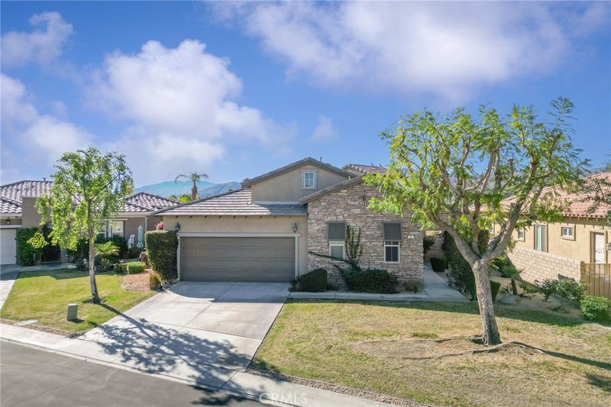 Enjoy peaceful lakefront living in the gated community of Mission Shores at Lake Mirage. This well-maintained 3-bedroom, 3-bath home features an open layout with a spacious great room, fireplace, and large windows capturing lake and mountain views. The kitchen offers granite countertops, a breakfast bar, and generous cabinet space. One of the bedrooms includes a private entrance, ideal for guests, an office, or flexible use. Outdoor space provides a tranquil setting overlooking the water—perfect for relaxing or entertaining. Additional highlights include a two-car garage, tile flooring, and access to community pools, walking paths, and scenic lakes. Conveniently located near shopping, dining, golf, and the new Disney Cotino Storyliving community, offering future resort-style amenities and entertainment nearby.