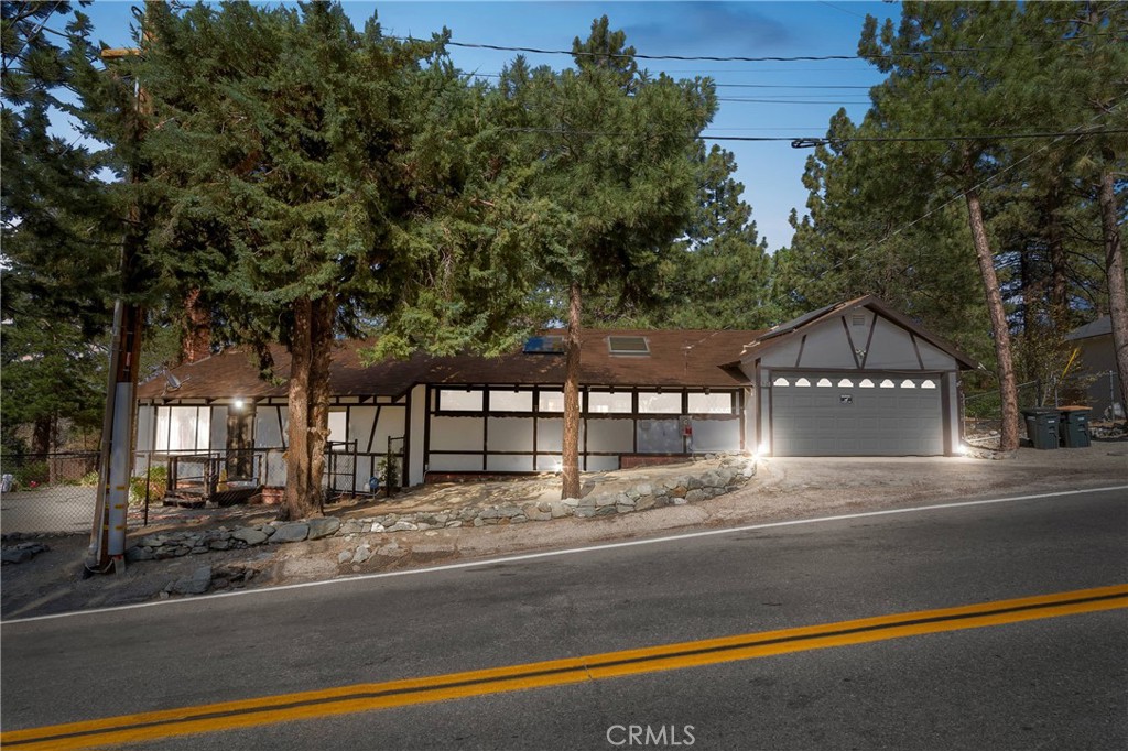 Welcome to 5821 Sheep Creek Drive, a charming Wrightwood retreat nestled on a desirable corner lot! This 2-bedroom, 1-bathroom home features a versatile flex space perfect for an art studio, game room, or potential third bedroom. Step inside to experience the traditional Wrightwood vibe, complete with real wood paneling throughout, creating a cozy mountain feel.
Enjoy the outdoors from the back porch or cultivate your green thumb with room to garden on the spacious lot. The property includes a 2-car garage and Tesla solar panels under a 20-year contract that began in 2014, offering low monthly payments and keeping your electric bill minimal year-round.
Don’t miss this opportunity to own a beautiful Wrightwood home full of character and possibilities—perfect as a full-time residence or weekend getaway!
Buyers and/or their agents to verify all information including utilities, solar contract terms, and property usage.