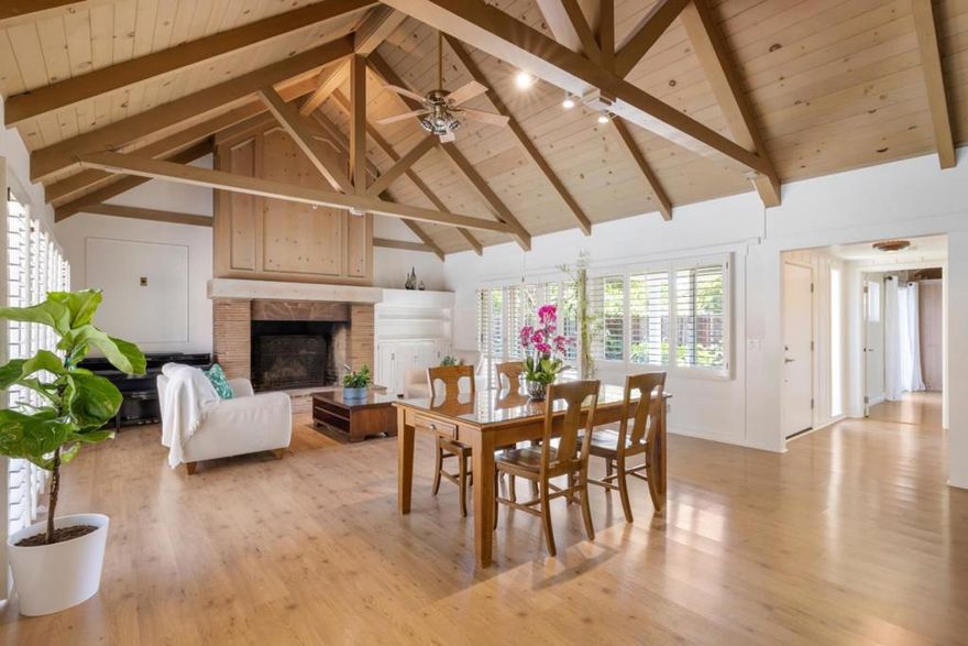 This enchanting Crescent Park home offers complete privacy and charm. Every room is crowned by a paneled cathedral ceiling with dramatic trusses, expanding dimensions and creating a remarkable sense of space. A gated courtyard with lush plantings provides outdoor living and a sunswept spot for vegetables and flowers. A covered porch opens to a welcoming foyer, leading to the living and dining room with nearly 16-foot ceilings, a striking stone fireplace, and French doors to both the courtyard and rear pool terrace. A walk-behind entertainment bar awaits gatherings, while the kitchen features pine cabinetry, limestone counters, and a greenhouse window. The adjoining breakfast area, framed by a bay window and Dutch door, adds another inviting space. 2 Br are arranged for privacy, each with distinct appeal. The rear Br  has poolside glass doors, a brick fireplace, and dual-entry bath access. The front primary suite opens to the garden courtyard with extensive built-ins & wardrobe space. California living continues in the rear yard with a pool beneath an arbor, surrounded by flagstone decking for lounging and entertaining. The cul-de-sac setting, across from Eleanor Pardee Park and blocks from Rinconada Park, is one mile from downtown, with easy access top-rated Palo Alto schools.