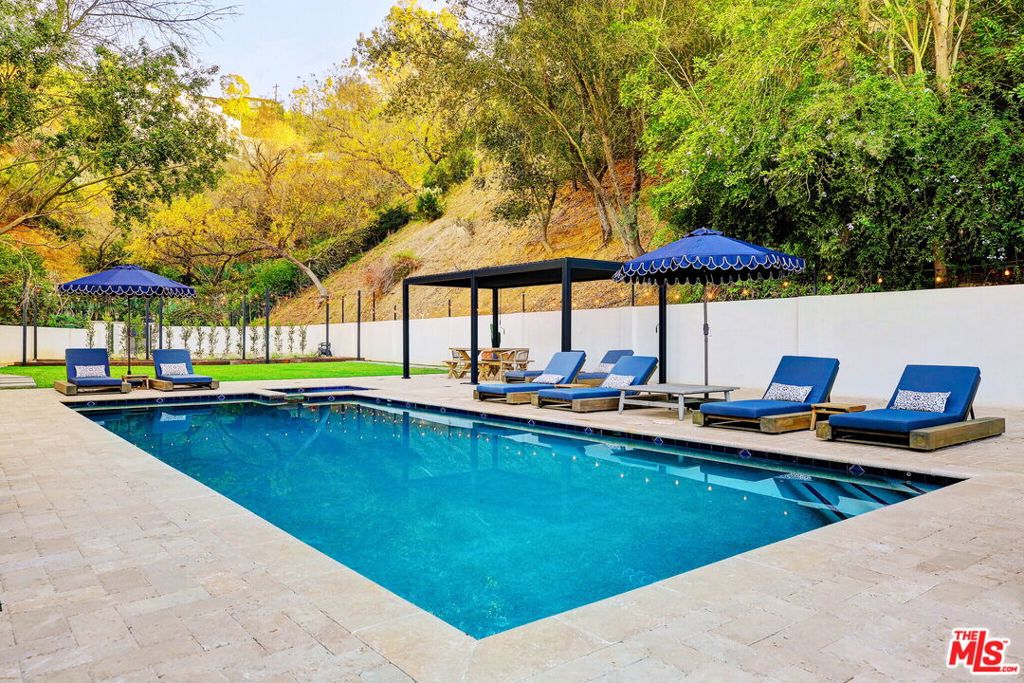 Welcome to 2570 Nichols Canyon Road, a truly unique Spanish Mediterranean Villa and Romantic Retreat that redefines urban living. This fully furnished 4-bedroom, 2.5-bath home boasts 3,535 square feet of living space, and sits on 1.3 acres across two adjoining lots, offering unmatched privacy and a resort-style atmosphere for $25,000/month. Designed for seamless indoor-outdoor living and entertaining, the heart of the home features a gourmet kitchen with top-tier appliances, a wood-burning pizza oven, and a wine cellar that holds 1,300 bottles. The open, airy floor plan includes spacious living and dining areas with high-beamed ceilings, while the private primary suite boasts a fireplace, patio, and a luxurious en-suite bath. Outside, enjoy breathtaking canyon views, an expansive pool and spa, multiple fire features, and game-ready bocce ball and corn hole areas. Two private yards and several stone-clad patios provide the perfect setting for alfresco dining and outdoor gatherings. With 9 off-street parking spaces and just minutes from the best of Los Angeles, this one-of-a-kind villa is a rare opportunity to live in luxury, style, and total seclusion. The home is located on a private road with parking for up to 9 cars. Offered fully furnished or unfurnished and available July 1st! Welcome to 2570 Nichols Canyon Road, a magical and ultra-private retreat, perfect for entertaining or simply unwinding and making unforgettable memories.