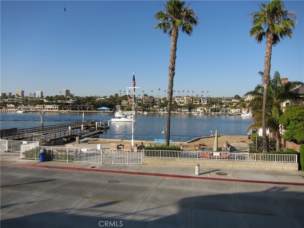 Enjoy spectacular unobstructed views of the harbor, the sparkling lights across the bay and a front row seat to all of the boating activities including the holiday boat parades. This spacious 4 Bedroom home is directly across from the bayfront beach and boat ramp so you can easily launch your kayaks, paddleboards and small boats. The second floor living room has a fireplace, separate office or entertainment alcove and adjoins the bay view dining room and beautifully appointed updated kitchen with Viking appliances and granite counter tops. The luxurious primary suite features a huge walk-in closet and tastefully remodeled travertine lined bath with a separate bathtub and glass walled shower. The private upstairs deck is accessed from the primary suite and the living room. The first floor includes a family room with a fireplace, three bedrooms, a full bath and a laundry room. A three car attached garage contains a separate work room and ample storage. The Peninsula Point features a voluntary association that includes use of the private beach, barbeque and boat launch directly across from this beautiful home. Enjoy the members only tennis courts and social activities, including a 4th of July Parade, Easter egg hunt and easy access to the Wedge, Balboa Ferry, Fun Zone, cafes and miles of sandy beaches. Unfurnished, yearly lease with option to extend. Available now, enjoy summer fun all year long!