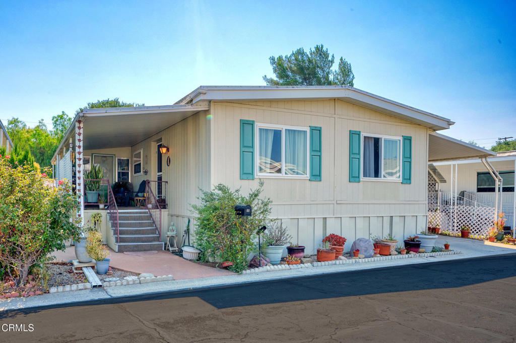 Welcome to 56 Don Antonio - a charming 2-bedroom, 2-bath mobile home nestled in the exclusive gated Ojai Villa 55+ community, offering stunning mountain views and a scenic walking path right behind the home. The open floor plan features vinyl-insulated windows, an updated kitchen, and a spacious primary suite with two closets and a dual-sink vanity. The guest bedroom enjoys its own separate bathroom for added privacy. Additional highlights include central A/C, a private backyard with breathtaking views, back gate access to RV storage, nearby bike trails, two large storage sheds, and more. This is Ojai living at its best!