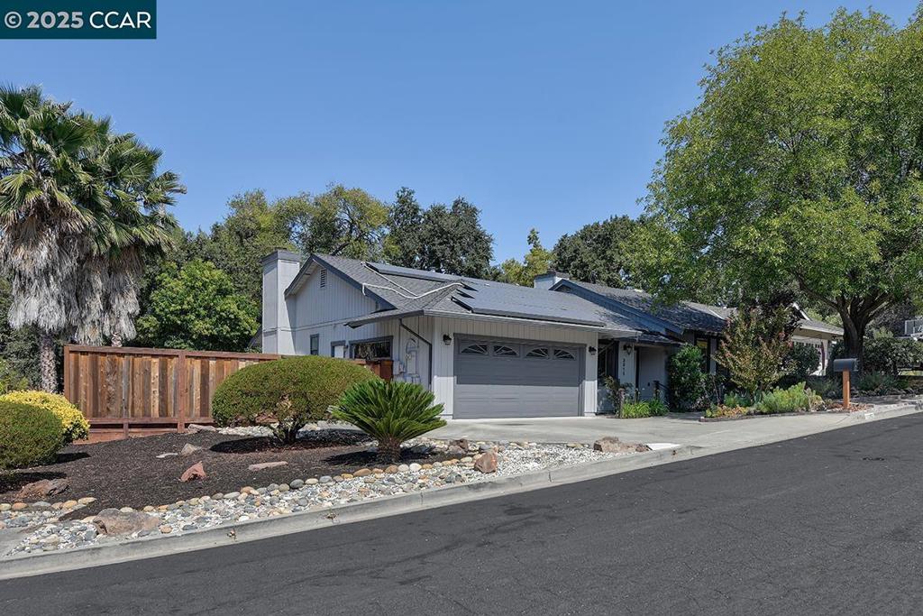 Welcome to this entertainer’s dream home—an updated split-level gem perfectly positioned on a premium corner lot in a quiet court location. Featuring 4 spacious bedrooms and 2.5 baths, this home offers a unique and functional layout with just three easy steps from the main living area to the upper level, where you'll find a private primary suite with en suite bath, three generously sized bedrooms, and a full guest bathroom. The main floor is filled with natural light from large skylights and showcases elegant hardwood floors, a formal dining room, an inviting living room with a gas fireplace, and a beautifully updated kitchen with ample storage that opens to a cozy family room with a second fireplace and direct access to a serene backyard retreat—perfect for entertaining or relaxing. Additional highlights include a laundry room, a convenient half bath, and interior access from the garage. With its exceptional layout, warm ambiance, and ideal location near shopping and commuter routes, this home truly offers the best of comfort, style, and convenience.