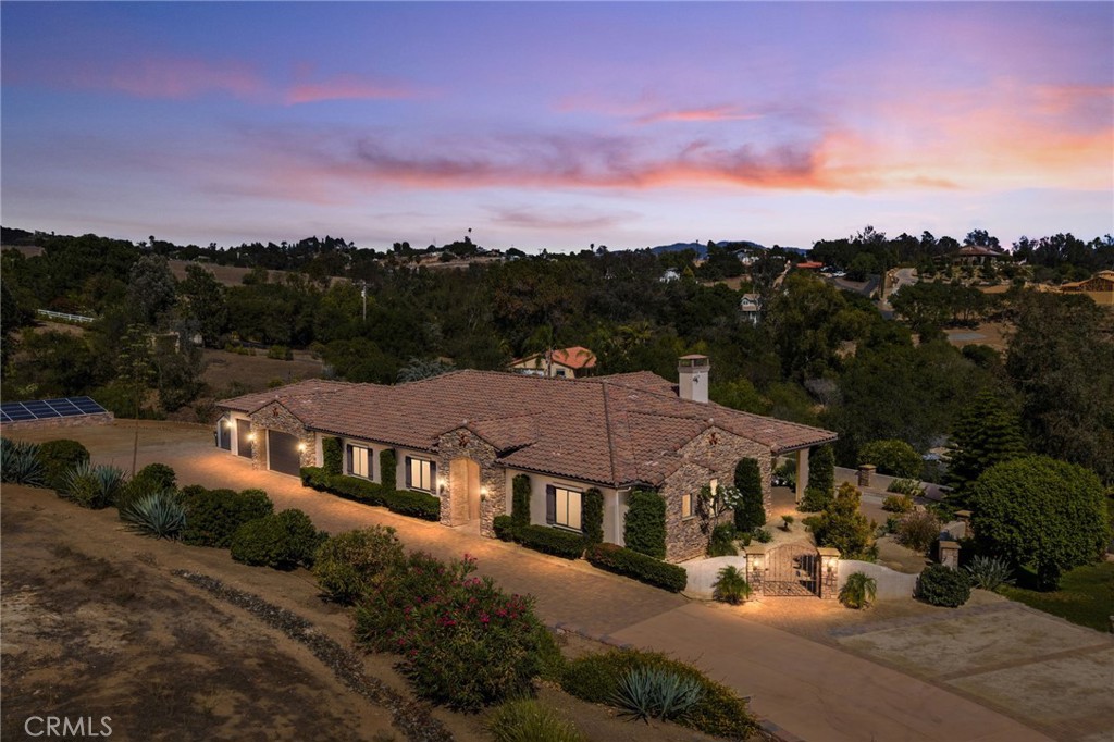 Relax and unwind in this spacious, custom-built single-level home, perfectly set on 1.83 private acres. Surrounded by drought-tolerant landscaping with water-saving emitters and paid solar, the property offers beauty with low maintenance and remarkably low energy costs.
The home boasts over 3,040 sq. ft. of living space plus a 1,000+ sq. ft. epoxy-finished 4-car garage. Designed around a great-room concept, the interior features 12’ ceilings, a stone fireplace, and oversized glass sliders leading to the serene back patio. The chef’s kitchen is a true showpiece, featuring Thermador appliances, double ovens, microwave, custom cabinetry, a farmhouse sink, and an expansive island with bar seating.
Each bedroom is generously sized with an ensuite bath, walk-in closet, and private patio access. The primary suite is a retreat of its own, offering dual closets, dual sinks with built-in toe warmers, a deep garden tub, and a spacious walk-in shower.
Throughout the home you’ll find travertine and engineered wood floors, central vacuum, Cat 5 wiring, and built in speakers. Outdoors, the inviting patio is perfect for entertaining with a built-in BBQ, outdoor sink and fridge, bar seating area, and peaceful surroundings that create a true indoor-outdoor lifestyle. There is ample space for an above ground spa with a dedicated area installed. The driveway is expansive and has a dedicated 3 stall parking area, in addition to the long paver lined parkway where you could fit many, many vehicles. There is ample room for an RV, toys, or other outdoor items that need to be parked. Additionally, there is a "botanical garden" with meandering pathways through the desert themed landscape. Walk along your DG paths under the trees and amongst the native plants.
Tucked away for seclusion yet still close to the city, this home blends elegance, comfort, and convenience for a lifestyle that feels like your own private retreat.