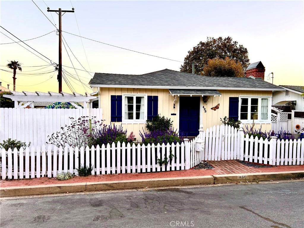 Looking for the quintessential Laguna Beach cottage? Come home to 425 Monterey Drive located in the renowned "Tree Streets". Built in 1935, this home has been tastefully upgraded and restored to reflect a quieter time when Laguna was basically an art colony by the sea. The home has beautifully restored hardwood floors, a remodeled kitchen and main bath, newer roof 2 years ago, new central air conditioning, a one car attached garage with direct access, and an ocean view from one of the two main bedrooms. There is a wonderful flower garden with a white picket fence out front. In the side yard is a brick floored patio area so you can enjoy the warm coastal sunshine and cool ocean breezes. The home has 2 bedrooms and 1 1/2 baths. This is a high demand location approximately 3 blocks from the crashing surf, Heisler Park and Las Brisas restaurant. Laguna's Main Beach and downtown Broadway and Forest Ave businesses are only about 6 blocks giving you easy access to Laguna's best amenities.