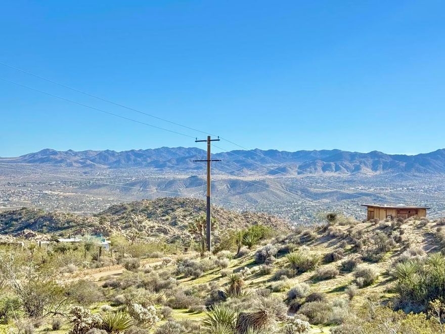 Elevated almost 600ft above and overlooking Yucca Valley. 5 acres perched on a hillside of boulder gardens! The lot gradually ascends about 50ft in elevation with opportunities for tiered building sites. Just outside the Western Hills Estates HOA.. Original mid-century homestead cabin. This location offers feelings of inspiration, vitality, accomplishment & will leave your guests spellbound. Magnificent rock formations. Million dollar homes in the area. Ideal for a modern designer luxury compound. Utilities appear to be right in the street. This neighborhood known for its designer homes, private settings, & unparalleled views. Natural fauna of cactus, Joshua Trees, & creosote bushes. Yucca Valley is a growing & trendy city. More celebrities, artists, & musicians are now calling this area home than ever before. Not far from the world famous live music venue Pappy & Harriets. Organic restaurants, cafes & bars are just down the hill. Short drive to town & all amenities. 12 miles to the Joshua Tree National Monument where about 3 million tourists visit annually. Only 37 miles to Palm Springs. 123 miles to Los Angeles. Rare opportunity for building your home in a dream location. Don't Wait! - Call Now! Buyers must contact the city planners on all questions on building & uses. Buyers must contact the utilities agencies for all questions on utilities. Address is not an assigned address & is for marketing purposes only. Don't Wait! Call Now! APN: 0596-101-01-0000 Property in HOA. GPS: 34.14154, -116.42968