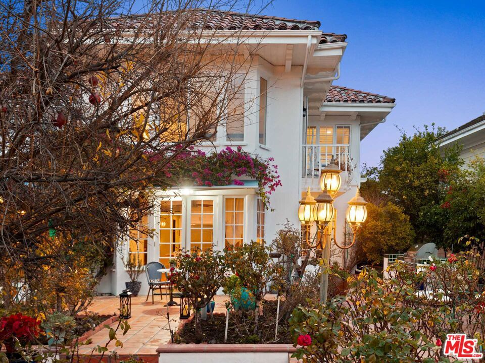 Welcome to your very own Mediterranean mountaintop retreat, behind gates in Brentwood's sought-after Mountaingate community. Wrapped with lush gardens and fruit trees, the home seamlessly blends old-world charm with modern upgrades and amenities. Enjoy canyon, city and ocean views, from the plush cabana, spa tub, various balconies and large windows across the 5,000 square foot residence. On the main level, a newly-built illuminated onyx wet bar connects the foyer with the living and dining rooms, serving as the ideal space for entertaining a large gathering, all crowned with exquisite Baccarat crystal chandeliers. A chef's kitchen with new appliances, expansive center island and abundant storage, spills out to the garden through French doors. A grand staircase leads to a hotel style primary suite complete with a sitting area, private balcony with ocean views, newly renovated spa-like bathroom with freestanding tub and large walk-in closet. Other amenities include an outdoor kitchen with grill and sink, massage room, exercise room, three-car garage, new hardwood floors, and over $600k in recent upgrades throughout. All this, behind gates with 24/7 security and easy access to the golf club, hiking trails, 405 freeway, and the world class dining and shopping of Brentwood and Santa Monica.