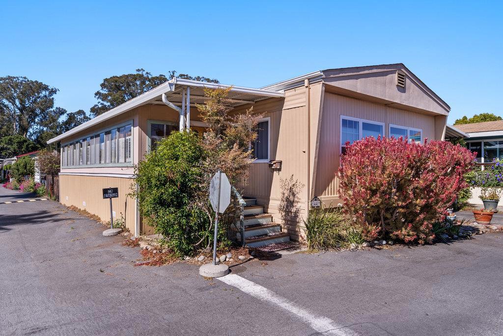 Great corner lot, close to Harbor and Beaches. The entrance to this lovely home brings you into the sunroom, lots of room for crafting, reading and entertaining. A nice prelude to the living area that is large and welcoming with plenty of natural light. The dining area offers a built-in buffet with plenty of storage. The kitchen offers modern appliance a gas cooktop and newer built in oven, refrigerator and dishwasher. Just off the kitchen the laundry/storage area door leads to the side yard. Co-op Park with low HOA fees.
