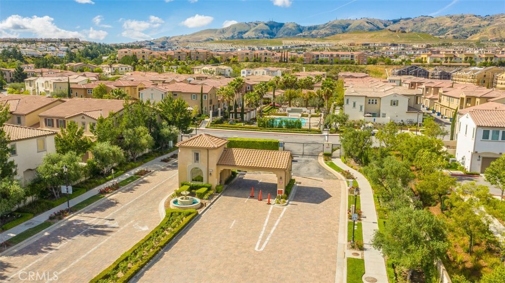 Located in the highly desirable gated Seville community, this spacious two-story townhome offers 4 bedrooms and 3 bathrooms with a thoughtful floorplan. The main level features a bright living room, dining area, and a gourmet kitchen with granite countertops, pantry, and stainless steel appliances, including a stove/oven, microwave, trash compactor, washer, and dryer—all included for your convenience. A bedroom and full bath on the main level provide flexibility for guests or a home office. Upstairs, the master suite boasts a walk-in closet and a full bath with dual sinks. You’ll also find Two additional bedrooms, lots of storage/linen cabinets in the hallway, and a convenient upstairs laundry room. Enjoy your private patio surrounded by lush landscaping, perfect for outdoor relaxation. The home also includes a 2-car garage.Residents have access to HOA amenities such as a sparkling pool, spa, playground, and BBQ area. Conveniently located near the 118 Freeway, Vineyard Shopping Center, restaurants, hospital, Whole Foods Market, and within the sought-after Porter Ranch Community School (K–8) boundary.