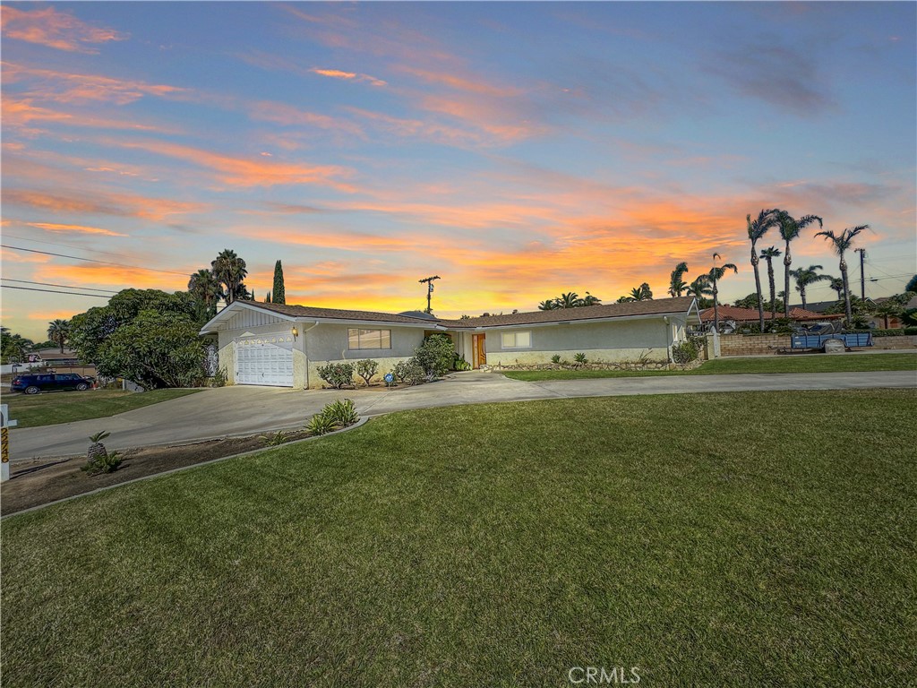Beautifully maintained single-story corner lot home in Grand Terrace, has excellent curb appeal with palm trees, rose bushes, and a spacious circular driveway. Has a detached two-car garage with a laundry room, garage has been split in half and used as a room. There is a covered breezeway between the home and garage—perfect for gatherings, relaxing, or entertaining. RV owners will appreciate the separate gated side driveway with RV parking, a built-in RV dump station, and an additional covered carport with a roll-up door for extra storage or vehicles. 3 bedrooms, 2 baths, all bedrooms have ceiling fans and mirrored closet doors. The spacious kitchen has ample cabinet space, tile flooring, and stainless-steel appliances (included with the sale). A separate dining area flows into the cozy living room, highlighted by a fireplace and window shutter blinds. Central air conditioning and heating ensure year-round comfort. There is a detached storage shed in the backyard, interior is drywalled and has a 1/4 bath (toilet). Conveniently located near shopping centers, parks, schools, and freeway access. Will not disappoint!