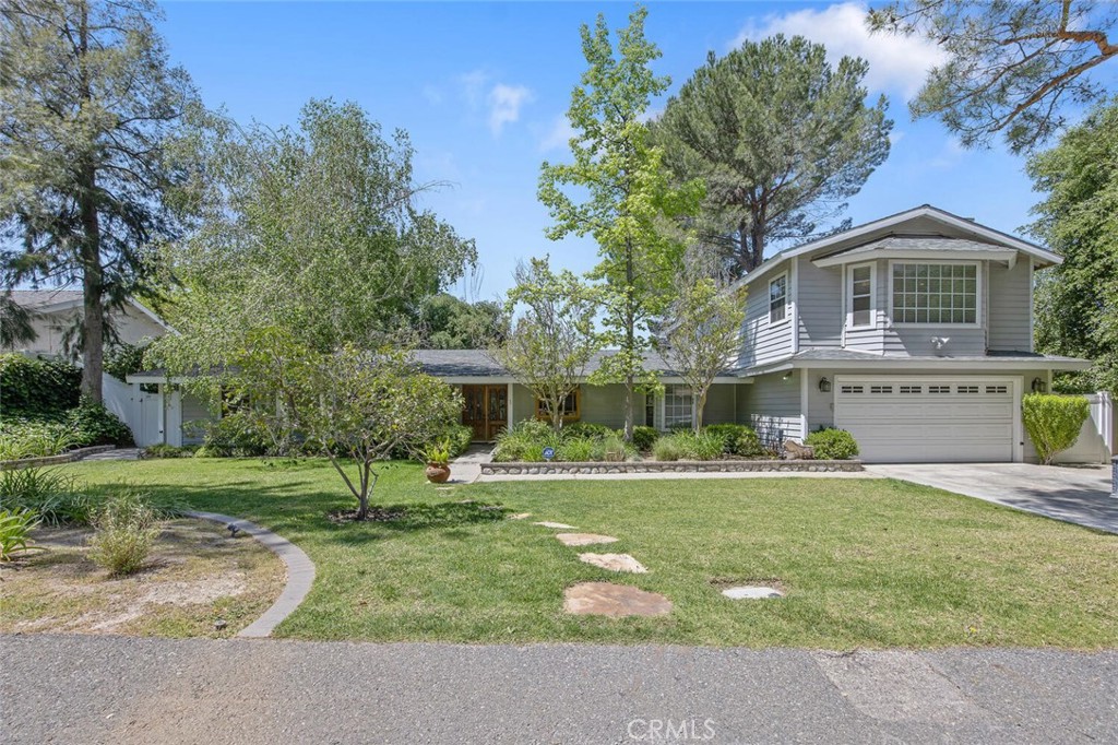 Spectacular 5 bedroom 3.75 Bath PLUS Pool Home/ ADU on a 3 Tiered, Private View Lot with Additional Lower Lot Access and Dual Primary Bedrooms! Tucked away on a quiet, tree-lined culdesac street, this tastefully upgraded and truly turnkey home offers the perfect blend of comfort, functionality and entertaining space with tons of privacy and a huge 50x20 Swimming pool with waterfall and waterslide! This initial single story 4 bed 2 bath design has been professionally expanded by adding an expansive additional primary suite upstairs with T&G vaulted ceilings, a cozy slate fireplace and luxurious en suite bath! This second primary bedroom now boasts its own sliding door access to the deck and picturesque Mountain Views with staircase leading to the above ground spa! On the main floor, you will enjoy comfortable and convenient living with high ceilings, remodeled kitchen, including stainless steel, built-in refrigerator, double oven, sit up breakfast bar and a charming family room with oversized picture window, including a built-in pet door for convenience! The main floor has 4 bedrooms and 2 full baths! This truly feels like a mountain getaway just minutes from the city! The main upper lot offers tranquil safety for children and pets to play! Step down the epoxy coated staircase to reach the second level which provides ample space to create incredible memories! A beautiful 480 sqft pool house complete with Murphy bed, half bath and kitchenette perfect for long term guests or an in-law suite with beautiful T&G ceilings and french doors overlooking the sparkling swimming pool, spa waterslide and garden area! There is even a half basketball court here as well! A few more steps down you’ll reach the lower lot which is an excellent space for soccer games, additional parking or even an additional living or stored space! This lot can also be accessed around Sand Canyon Road is Complete with a rolling gate for vehicle access! This is a unique property that you will cherish for yours to come!