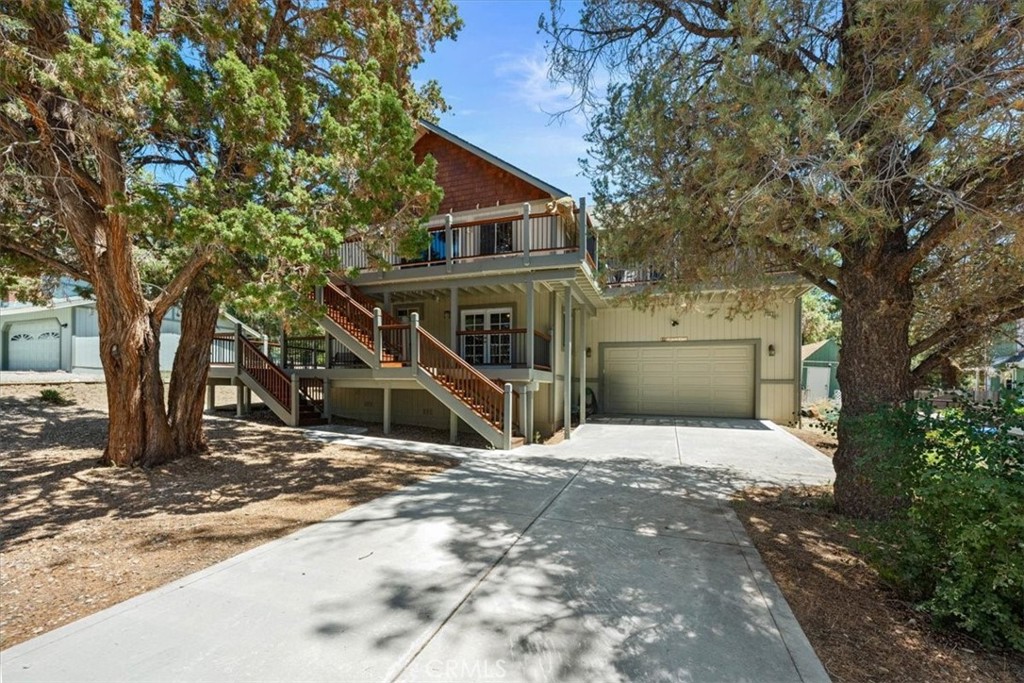 Welcome to this beautiful 4-bedroom, 3.5-bathroom home located in the peaceful and highly desirable Whispering Forest neighborhood of Big Bear City. Just minutes from the lake, ski resorts, hiking and biking trails, shopping, and dining, this home offers the perfect blend of quiet mountain living and convenient access to everything Big Bear has to offer. Step inside to find a spacious and open layout featuring a large great room—perfect for relaxing or entertaining family and friends. The expansive kitchen is equipped with ample counter space, a breakfast bar, and plenty of storage, making meal prep a breeze. Two of the bedrooms are primary suites, offering privacy and comfort for multi-generational living or guest accommodations. With lots of storage throughout, an attached 2-car garage, multi-level decks, and a fully fenced backyard, this home is both functional and family-friendly. Whether you're enjoying cozy evenings by the fire, hosting holiday gatherings, or using the space as a retreat for guests, this home offers flexibility and warmth. Ideal as a full-time residence, weekend getaway, or vacation rental, this well-maintained home is move-in ready and waiting for you to make it your own. Don’t miss your chance to own a piece of Big Bear paradise in one of its most tranquil neighborhoods.