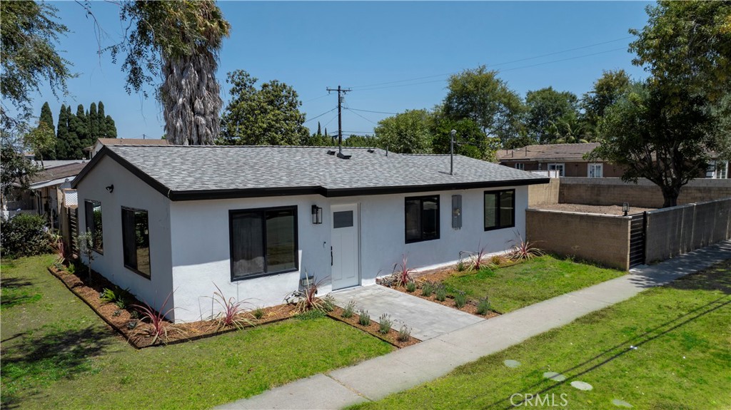 Discover this turnkey Santa Ana gem within blocks from historic Main Street in old town Santa Ana, with close access to the 55 and 405, John Wayne and South Coast Plaza — a fully remodeled home with permits offering high-end finishes, modern systems, and an expansive private lot. Situated on a huge corner lot in the heart of Orange County, this property is perfect for first-time buyers or investors looking to expand with an ADU or home addition.
Everything is NEW and has been thoughtfully done: brand-new roof, new waterproof thick luxury vinyl wood floors, and vaulted ceilings with R-30 insulation. Enjoy new drywall and paint, new exterior stucco, all-new windows and doors (including a privacy WiFi-controlled exterior door), and walk-in closets. The chef’s kitchen boasts premium wood cabinets with soft-close doors and drawers, quartz countertops with matching backsplash, and stunning white-and-gold appliances — refrigerator, range, hood, dishwasher, and washer/dryer tower.
Major systems are fully modernized with a WiFi-controlled ductless mini-split (3 zones), new tankless water heater, new plumbing re-pipe throughout, new 200-amp electrical panel, new wiring, outlets, switches, and ceiling lights, plus an EV charger outlet in the yard. Tech features include wired Ethernet for exterior POE security cameras, a WiFi doorbell, and AT&T fiber internet availability.
Outside, enjoy mature trees, a new concrete patio, front porch pavers, and complete privacy with brick walls and new steel gates. There’s secure inside-gate parking for a boat, RV, or business equipment. The spacious lot is ADU-ready and offers room to expand the home for additional income potential.
With all work completed with permits, this property is a rare blend of style, function, and investment opportunity.