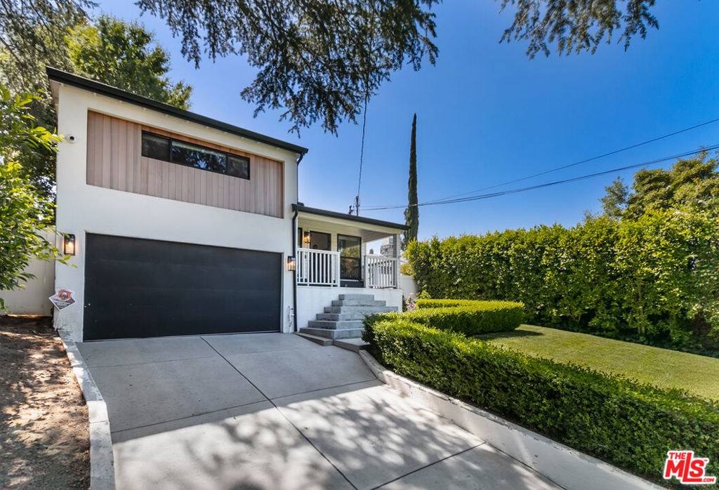 Nestled serenely South of Ventura Boulevard, this remarkably upscale, contemporary Craftsman Bungalow welcomes you with mature landscaping and a lovely gated driveway, fostering quiet privacy to begin your unique experience within this modern retreat. As you approach, a classic front porch invites you in. Upon entering, you are immediately struck by the clean lines, open spaces and thoughtful artistic touches throughout the home. Designer finishes abound, with wood floors, vaulted ceilings and large double-paned windows bathing the effortless flow of the Living Room, Dining, and Kitchen areas in natural light. The kitchen is a chef's dream, boasting shaker-style cabinetry, stainless steel appliances including a Subzero refrigerator and a custom-built desk. This thoughtfully designed bungalow offers two spacious bedrooms, that include a Primary Suite and beautifully remodeled bathrooms, accommodating all your needs with simplicity and grace. Additional features include central heating and air conditioning, a convenient laundry room with utility sink and a Nest thermostat. The lush, expansive outdoor spaces present endless possibilities, with multiple areas for dining, entertaining, and socializing, including a delightful pergola. Enjoy the convenience of many nearby local dining and coffee favorites, Whole Foods Market, and the scenic Corbin Canyon Park hiking trails, offering a beautiful lifestyle. This sanctuary creates a harmonious experience that will make it difficult to leave, offering the ultimate in ease and lifestyle. A beautifully taken care of home that embodies exquisite taste and style, offering the ultimate and best of modern living in a prime location. Other Amenities include: Tesla EV Charger in the Garage and Storage Space in the Garage.