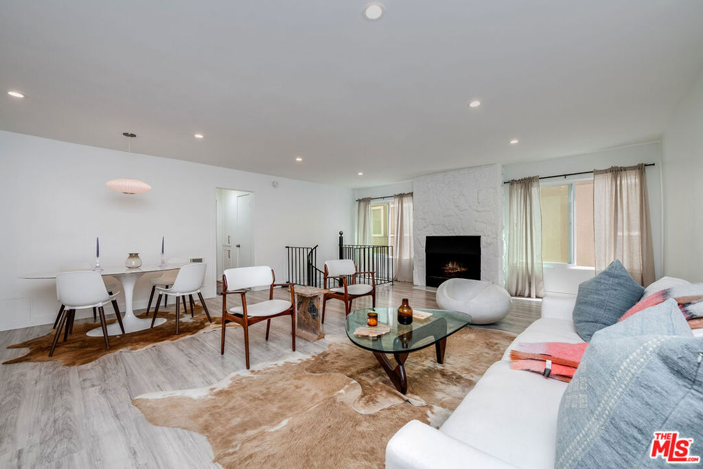 Experience coastal living at its finest in this beautifully updated two-story corner condo, just steps from the sand on the coveted south end of the Marina del Rey Peninsula. Thoughtfully renovated with a sleek, modern aesthetic, this home offers a bright and airy main level with an open floor plan that includes a dining area, cozy living room with fireplace, and a custom-designed kitchen featuring warm wood cabinetry, quartz countertops, and stainless steel appliances. Upstairs, the primary suite occupies its own private level, complete with a stylishly remodeled en-suite bathroom. The second bedroom offers great natural light, generous closet space, and a sense of seclusion. Enjoy ocean breezes and views from your private balcony, overlooking the picturesque walk street of Quarterdeck. A second, beautifully finished bathroom serves the main level. The unit also includes two parking spaces in a secure, elevator-equipped building, all within a short distance to the beach, Abbot Kinney Boulevard, and some of the best local shops and restaurants in LA. Beachside living at its absolute finest.