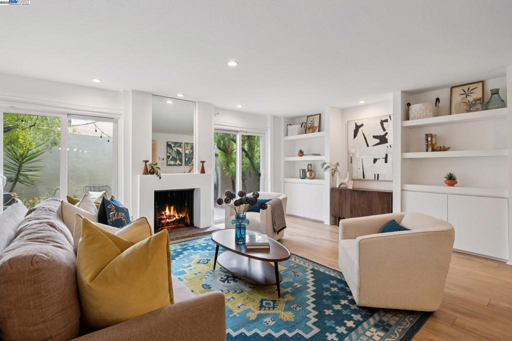 This spacious two-story townhome offers 3 bedrooms and 2.5 bathrooms. The open-concept main floor features recessed lighting, stylish LVP flooring, and an abundance of built-in cabinets and shelving that provide ample storage. Large sliding glass doors fill the living area with natural light and open to lush greenery for an inviting indoor-outdoor flow. The dining area is accented with built-in cabinetry and connects seamlessly to the updated kitchen, complete with newer appliances, under-cabinet lighting, and a convenient pass-through window. A half bath and laundry room complete the main level. Upstairs, parquet flooring flows through three well-sized bedrooms, including a primary suite with an en suite bathroom and a walk-in closet. Across the courtyard, a two-car garage provides secure parking and storage. Additional upgrades include a newer tankless water heater, furnace and dual-pane windows. Community amenities feature a pool and playground, all near top schools, Corica Park Golf Course, trails, and the SF Ferry for easy commuting. Open House Sat & Sun 2-4pm.