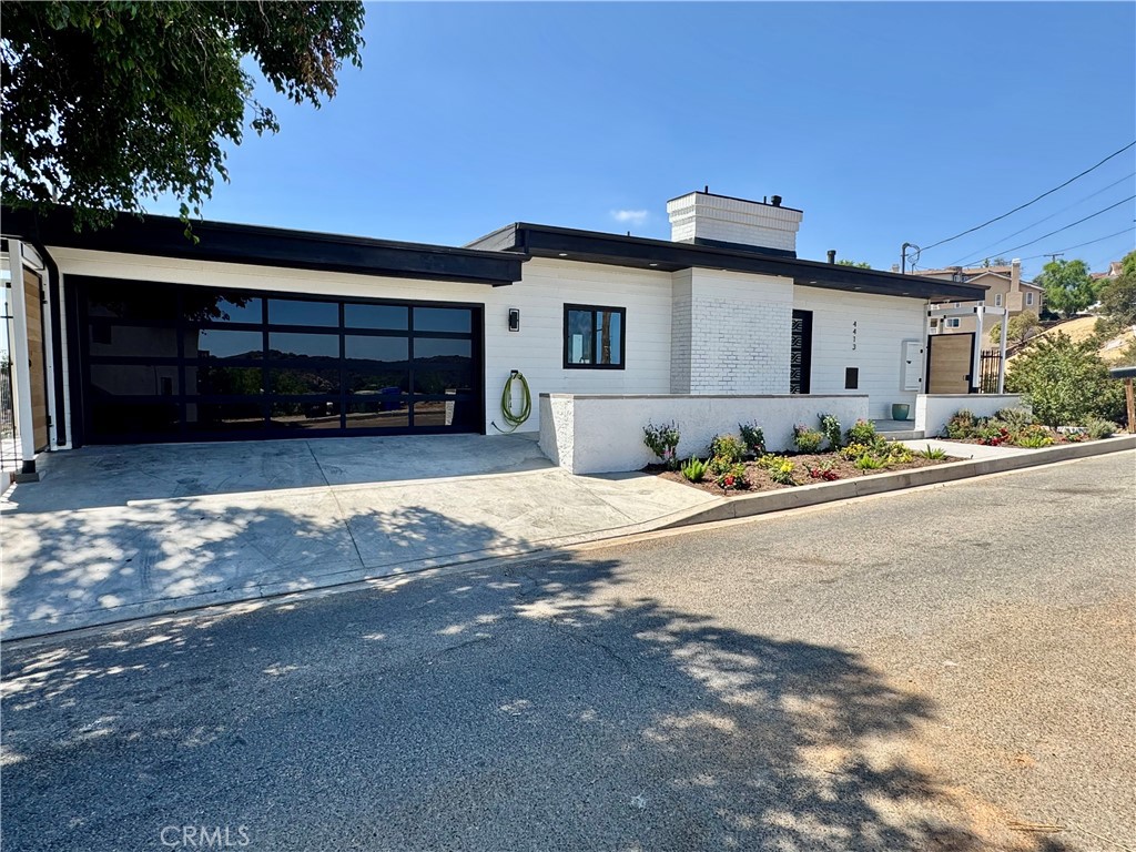 Welcome to your Sky House retreat in the picturesque Woodland Hills neighborhood, where breathtaking valley and mountain views await. This enchanting multi-level, Mid-Century Modern style home is perched high above the San Fernando Valley, south of Ventura Blvd, offering a perfect blend of artistic design and natural beauty. Step inside to discover expansive living spaces filled with warmth and character. The inviting living room features a cozy fireplace and opens to one of several decks ideal for enjoying the stunning vistas and peaceful surroundings. With three spacious bedrooms and two versatile suites, there's ample space to relax, create, and entertain. The chef's kitchen is designed for culinary creativity, offering generous storage, pantry space, and an intuitive layout perfect for both entertaining and quiet evenings at home (all equipped with soft closing drawers and cabinet doors). Both levels each have their own attached decks offering an additional 800 square feet of exterior space per level. The open-concept living and dining areas ensure easy flow for gatherings. The primary bedroom is a true haven, complete with an attached sitting deck with panoramic views, a walk-in closet, and a stylish en suite bathroom featuring dual vanities, a free standing bath tub, heated towel rack and a large frameless glass shower.