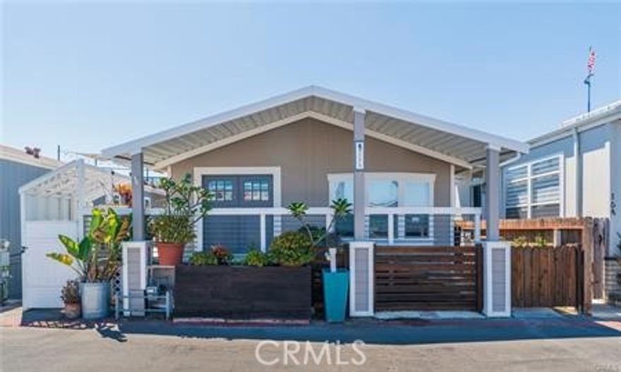 Freshly painted Beach Home awaits you! When you walk up to this home it feels more like a "SFR" than a manufactured home. Enter through the gate and up the wide expansive staircase to the HUGE OPEN Porch. Wow! Showstopper right there! It even winds around the home for a private seating nook on the side of the home. Open the Cutsom Dutch Doors and enter the Extra LARGE living room with its quaint rustic designs, reminiscent of an upscale cabin on the water. You will love the Fireplace and open layout to the kitchen island. Lots of Floor to ceiling windows make this beauty light and bright all year long. You will love the fact that all the bedrooms are in the back with plenty of distance between them and the third bedroom is even more of a delight with steps outside leading up to the LARGE DECK WHICH OVERLOOKS THE BEACH! SAND views.. Watch the 4th of July fireworks, concerts, sports and yearly Blue Angels air show. *You can even put in a large wheelchair access elevator in the third room section as there is tons of room! Private side yards with gates for those who have animals and many cute little nooks to have additional areas for reading/ coffee/tea or cute safe enclosed areas for toddlers.. maybe even grow an herb garden! Custom built trash containers make it even easier on those pesky trash days to move the bins in/out for those with agility issues or just "making life easier" This home is priced well to sell and awaits new owners who want year-round Beach Life! Home views Catalina Island/HB Pier and is just across the street for walking, biking, fire pits, surfing and more.. Stop by and see what this little paradise is all about! Space rent $3461.00