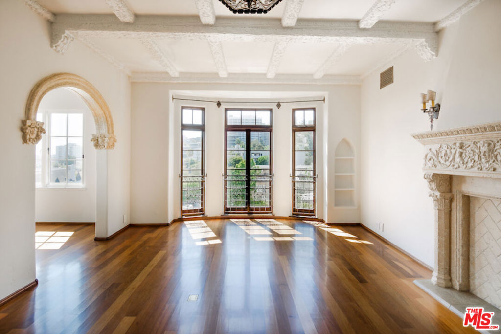 After nearly a century standing proudly in the heart of West Hollywood, the breathtaking El Mirador Apartments reopens its doors. Reborn, refined, and ready to welcome a new generation of residents. Following more than a decade of meticulous and sensitive restoration, this architectural jewel is a prime example of Churrigueresque Spanish Colonial Revival design and has been returned to its original splendor. Built in 1929 by renowned theater architect S. Charles Lee, it stands as a remarkable tribute to its era. Original floorboards were carefully lifted, revarnished, and placed back with reverence. Decades of paint and primer were patiently removed from hand-carved archways to reveal the craftsmanship beneath. Custom-imported rugs now line the grand corridors. Every salvageable element of the building's storied past has been preserved, fought for in some cases, with an unrelenting commitment to authenticity. In El Mirador, the devil is not just in the details. It is in the devotion. Inside each residence, modern comforts blend seamlessly with historic charm. Kitchens feature state-of-the-art appliances set in sleek marble surrounds. Discreet cabinetry conceals in-unit washers and dryers, while retractable screens disappear into window casings to preserve uninterrupted views. Modern comforts seamlessly blend with historic charm.