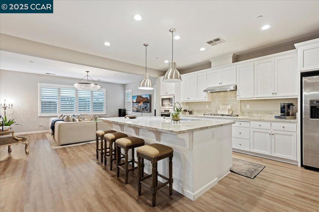 Situated in the sought after community of Emerson Ranch welcome to 369 Parkfield Way. Built in 2018 this 3,572 sq. ft. two-story residence blends comfort and style with numerous upgrades throughout. Upon entry you'll find the first office, a formal dining/bonus room that connects through to the chef's kitchen that features, quartz countertops, stainless steel appliances, an expansive island for five, and a walk-in pantry with prep counter and storage. The open kitchen-family-dining layout is perfect for everyday living. A main-level bedroom and full bath offer convenience for guests or multi-generational living. Also on the main level is a second office/workspace with built-ins. Upstairs boasts a spacious bonus room, four bedrooms, three baths, and a large laundry room with built-in cabinetry and counter space. The private primary suite features a spa-like bath with a soaking tub, a walk-in shower, dual sinks, and a grand custom walk-in closet. Step out back into the California room with two separate fire pit areas and space to add to your dream backyard. This home also offers a 2 car garage with tandem parking and plenty of storage. Don't miss this exceptional home!