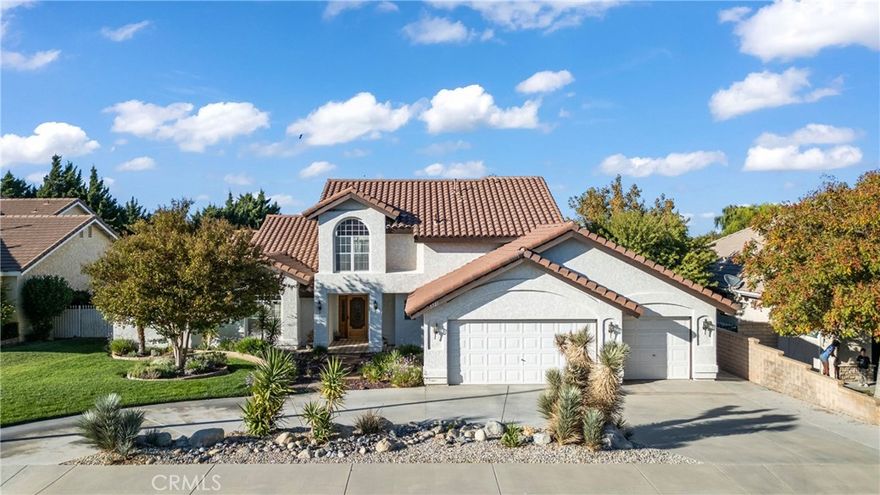 Big, Beautiful Home with Pool in a Prime Antelope Valley Location! Near shopping, schools, and parks – truly a great location!

Discover the best of both worlds—inside and out—with this elegant, meticulously maintained home tucked away on a quiet, desirable street. The property showcases mature landscaping, a manicured front yard with concrete steps, a brick pathway leading to a custom entry door, and a spacious three-car garage. Inside, dramatic high ceilings, solid wood doors and trim, and a blend of tile, carpet flooring, set a warm, upscale tone. The kitchen offers abundant cabinetry, a side cooking counter, and stainless-steel (black color)double oven and dishwasher. The inviting family room features a custom fireplace and opens to the formal living and dining rooms. French doors lead directly to the backyard where you’ll find a sparkling pool, soothing spa, and cozy fire pit—perfect for entertaining and relaxing. Upstairs, the luxurious primary suite boasts a large walk-in closet, sitting area, and a spacious bathroom complete with a jetted tub large walk in closet. From the study area, step out onto a private balcony with panoramic views overlooking the pool and backyard. The downstairs secondary bedrooms are roomy and comfortable—one with French doors offering direct pool access.

The backyard is your own private oasis, featuring newer pebble-stamped rock landscaping, mature trees, colorful plants, and a tranquil setting ideal for relaxation or hosting gatherings Around pool or Fire pit. This home has been lovingly cared for and offers timeless style and modern comfort in one of the Antelope Valley’s most sought-after neighborhoods.