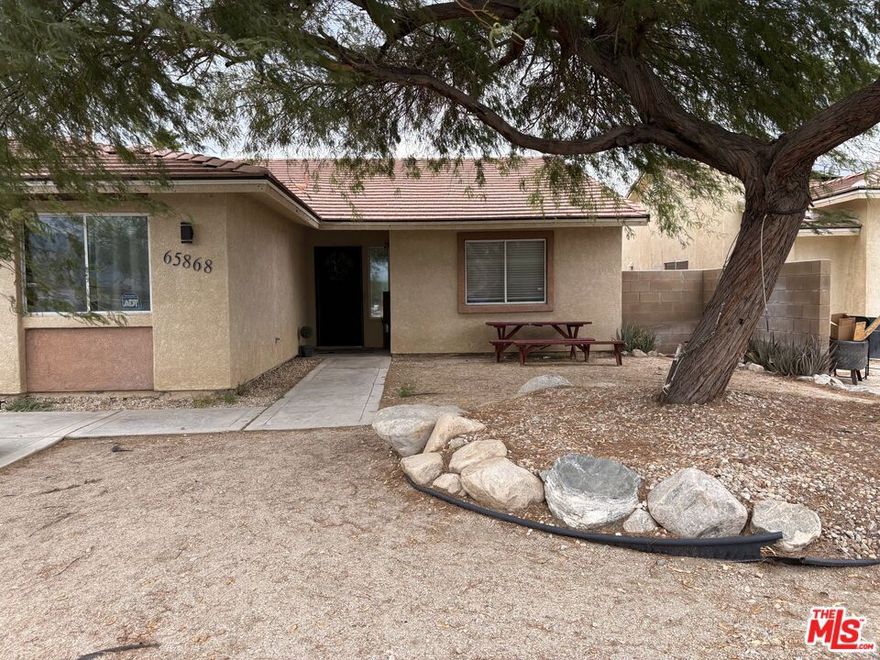 This beautifully maintained 4-bedroom, 2-bath home offers the perfect blend of comfort, space, and opportunity. With a generous open floor plan and tile flooring throughout, the home features a large kitchen ideal for cooking and entertaining, a cozy living room with a fireplace, and ceiling fans in every room to keep things cool year-round. Sitting on an oversized lot, the backyard is fully enclosed with a block wall for privacy and offers endless potential design your dream pool, build an ADU, or create the ultimate outdoor lounge. RV parking and plenty of space for toys make this property ideal for families, hobbyists, and adventurers alike. Located in a desirable neighborhood, you're just minutes from grocery stores, local parks, downtown Palm Springs (12 minutes), and Joshua Tree (25 minutes). Whether you're looking for a full-time residence, vacation home, or investment property, this one checks all the boxes.