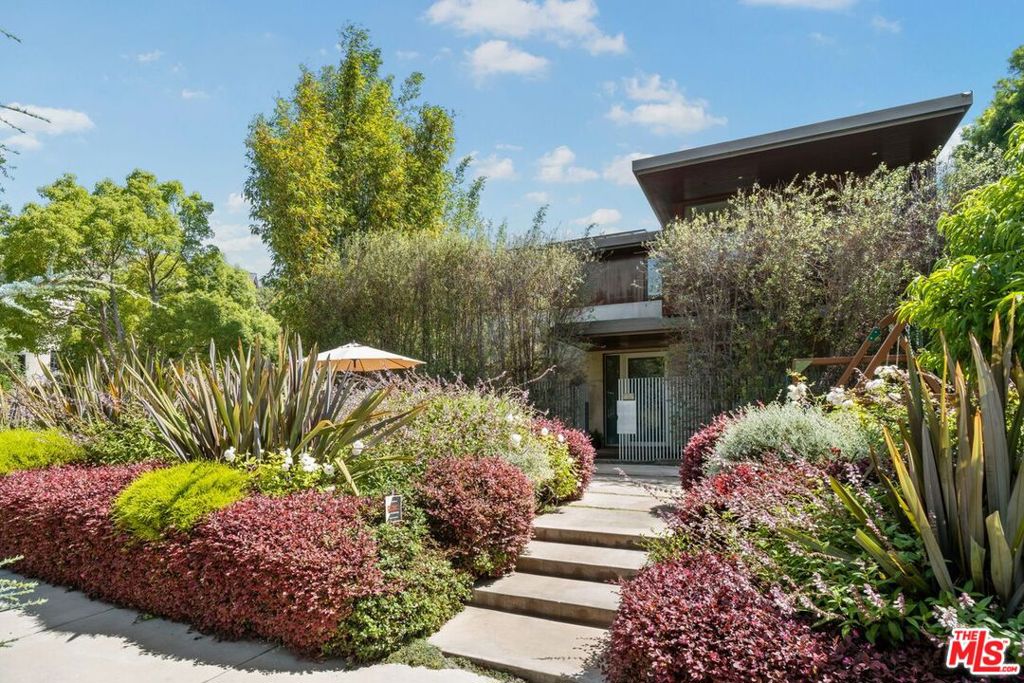 Set on a prime corner lot in the highly sought-after north of Montana area, this elegant and refined architectural residence offers spectacular living in an exceptional location. This is a spacious and special property for discerning buyers. Quality construction and impressive materials anchor the three expansive levels of this home, providing a sophisticated and stylish environment in which to live, work, play and entertain. Boasting high ceilings and transom windows, the design details have a classic and timeless elegance that is lasting. Large, sliding doors dramatically span seamlessly to the yard which features a pool, truly offering an indoor/outdoor living room that takes full advantage of the large lot. With four bedrooms upstairs, highlighted by the primary suite with its treetop views and striking, serene bathroom, this beautifully maintained home is currently configured with two work-from-home offices, and a spacious basement/lower level with a media/theater room, an outfitted gym, plus a bar and large seating/library this one has it all. There is a wonderful, reassuring feeling of privacy and security in this property and yet the proximity can't be beat: perfectly situated between The Brentwood Country Mart and close to upscale shops and restaurants on Montana Avenue, plus easy access to the beaches or further into town. An exceptional opportunity for elevated living in a great location. This special residence features luxury materials and choices, including gorgeous hardwood floors, 5 separate air conditioning zones, solar panels, a bonus rooftop deck/lounge, plenty of storage and a spacious two-car garage with Tesla charger.