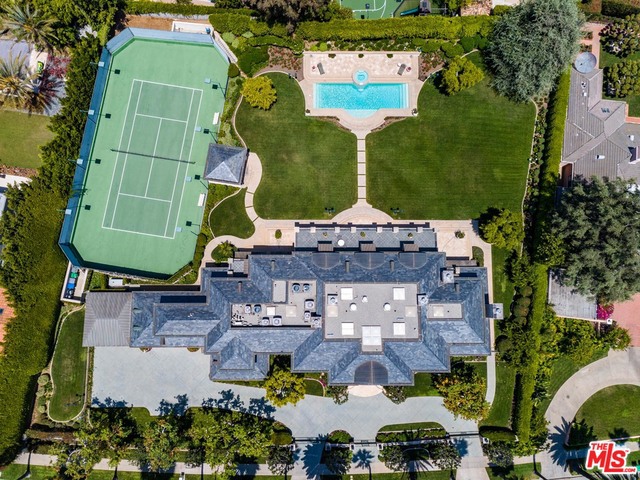"Timeless Classic" - A rare offering in the Estate Section of Beverly Hills. Poised on 1.1 acres at the top of gentle slope, this gracious Traditional is perfect for both intimate gatherings and grand entertaining. One block from the Beverly Hills Hotel. Built by renowned construction firm McCoy - the quality is unparalleled. Sky lit 2-story entry foyer with sweeping staircase and wrought iron railing. Classically detailed with wide hallways and 12ft ceilings. Grand public rooms include: formal dining room, baronial living room, card room with bar, wood paneled library. Gourmet Kitchen and breakfast room. Master Suite with dual baths and large walk in closets. 5 additional bedrooms all with ensuite baths. Outside a massive grass lawn, pool and spa are bathed in sunlight and punctuated with palm trees. A lighted Tennis Court and BBQ pavilion complete this exceptional estate. Shown only to pre-qualified Buyers.