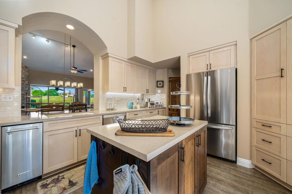 STUNNING LEGENDS 20 RESIDENCE WITH DOUBLE FAIRWAY & PANORAMIC MOUNTAIN VIEWS! The highly sought-after Legends 20 model at PGA West combines elegant design, spacious interiors, and a premier location within one of La Quinta's most prestigious guard-gated communities. Offering 3 bedrooms, 3.5 bathrooms, and approximately 2,596 sq. ft., this residence delivers the perfect blend of comfort and resort-style living. Soaring vaulted ceilings, abundant skylights, and an open floor plan fill the home with natural light. The main living area is anchored by a dramatic floor-to-ceiling stacked-stone fireplace and features luxury vinyl flooring and a built-in wet bar, creating the perfect space for relaxation or entertainment. A remodeled gourmet kitchen showcases quartz countertops, custom cabinetry, stainless-steel appliances, gas cooktop, under-cabinet lighting, recessed ceiling lights, and expanded storage, making it ideal for both everyday living and special gatherings. The primary suite is a true retreat with direct patio access, custom closet, and a spa-inspired bath complete with a frameless shower featuring dual heads, a freestanding soaking tub, Newport Brass fixtures, dual vanities, and expanded storage. Two additional bedrooms, each with en-suite baths, provide privacy and comfort for family or guests. Outdoor living is equally impressive, with panoramic mountain and double fairway views of the Stadium Course. The spacious patio includes a built-in grill and plenty of room for dining or lounging, while the community pool is conveniently located right across the street. UPGRADE HIGHLIGHTS INCLUDE: luxury vinyl flooring in main living areas, floor-to-ceiling stone fireplace, Waterboy whole-house water filtration system, refurbished entry door, ceiling fans throughout, and a golf-cart garage with custom cabinetry and overhead storage. The property is offered turnkey furnished, excluding Seller's personal items and those listed on the exclusions list. Residents of PGA West enjoy a world-class lifestyle with access to championship golf, multiple clubhouses, dining, fitness, tennis, pickleball, and resort-style pools. This Legends 20 model showcases the perfect combination of luxury, convenience, and the active desert lifestyle that makes PGA West one of California's most desirable destinations. *Some exterior and landscape photos have been digitally enhanced for illustration only.